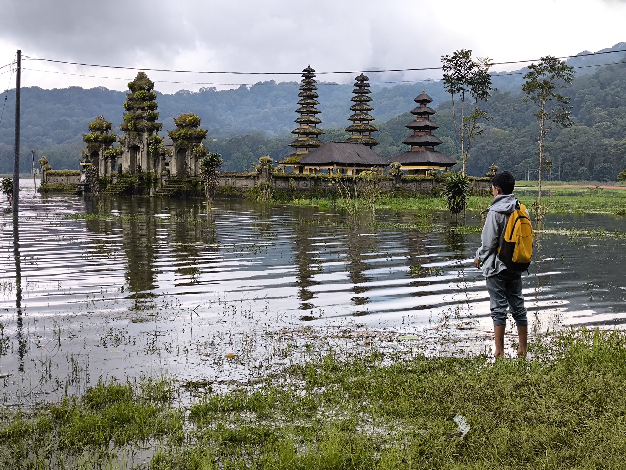 Fishing and temple scenes documented in Indonesian forest setting