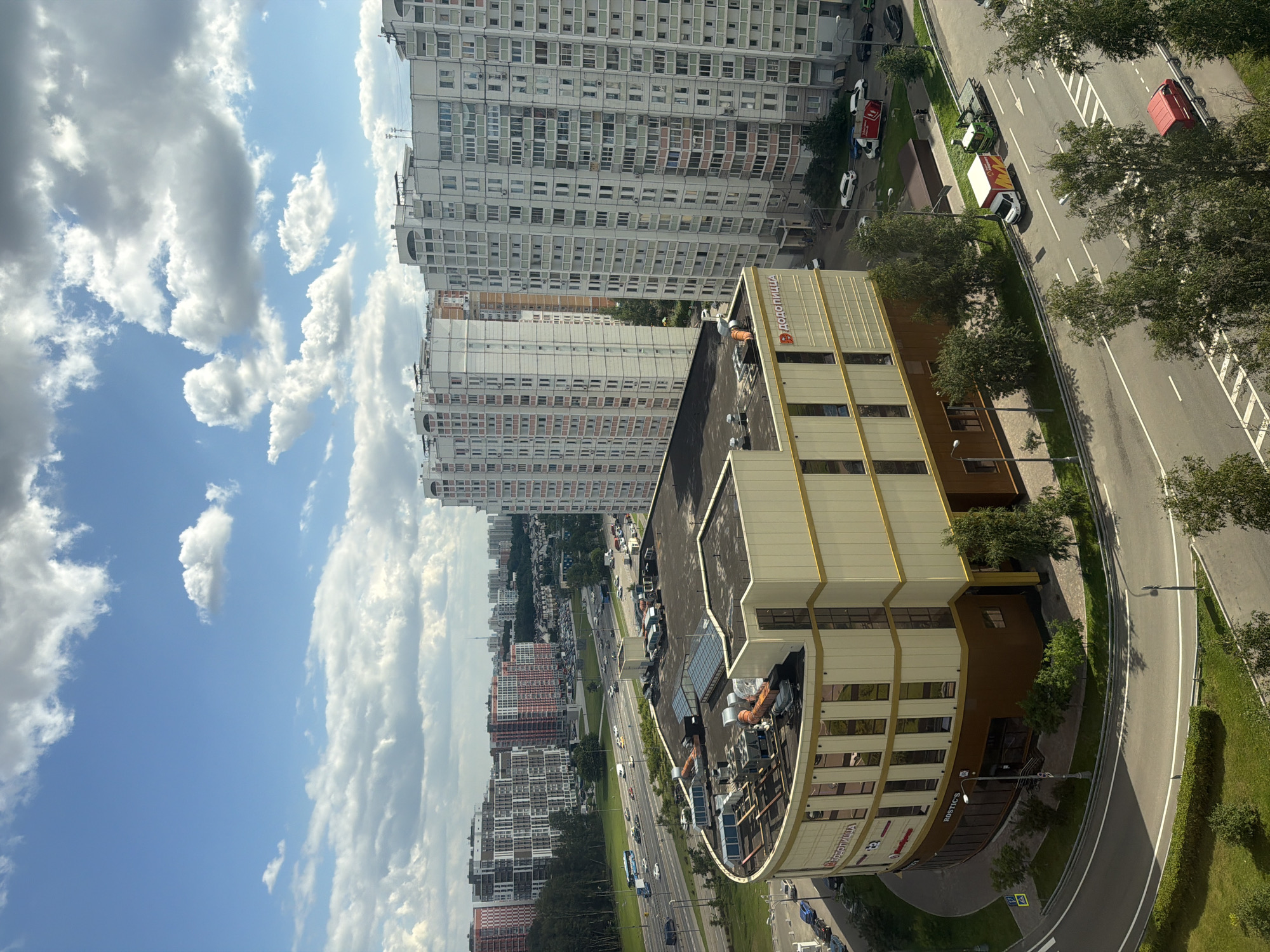 Aerial views of a curved Moscow commercial building, with a few odd ones out