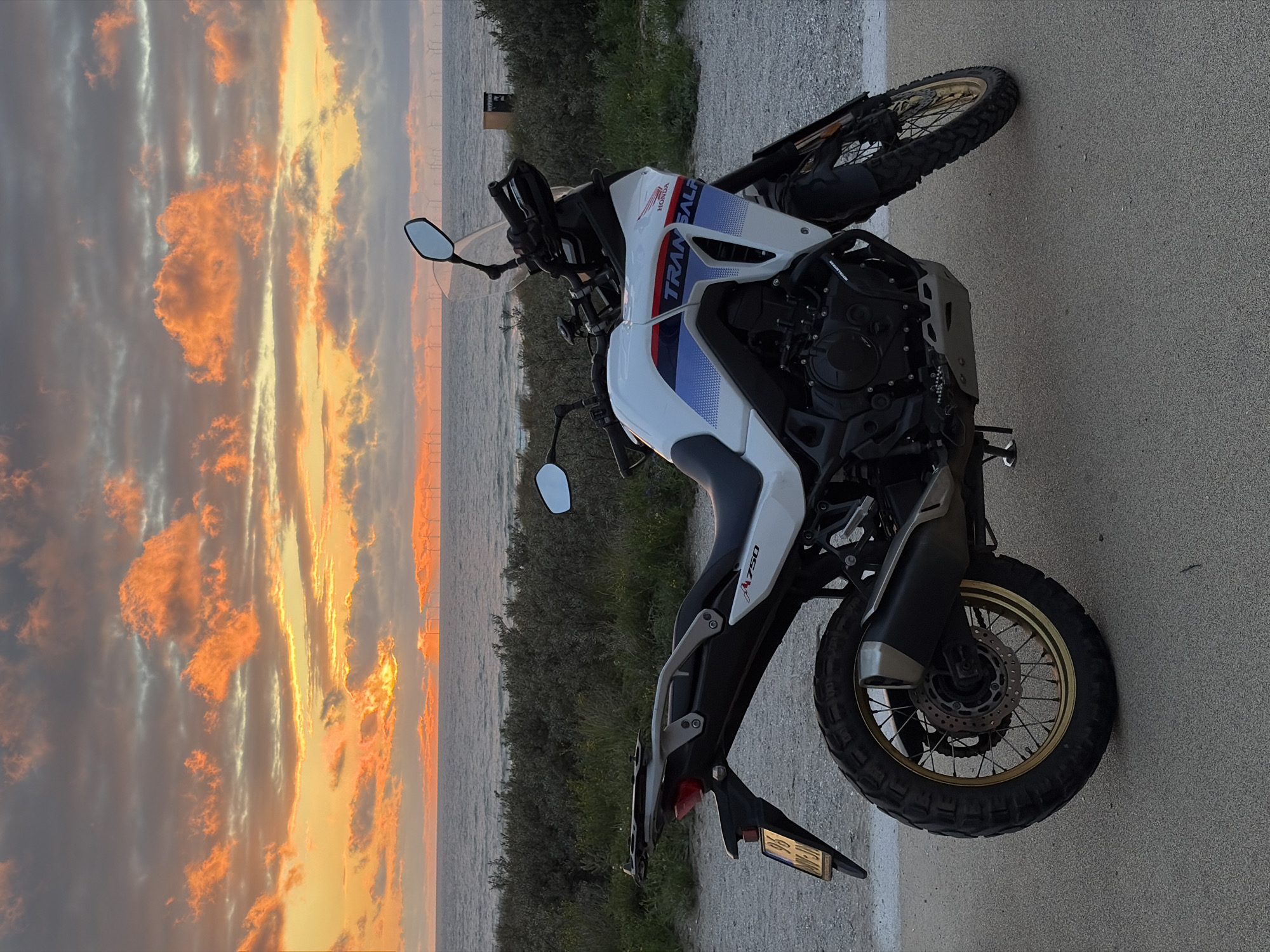 Adventure motorcycles positioned for North Sea sunset viewing