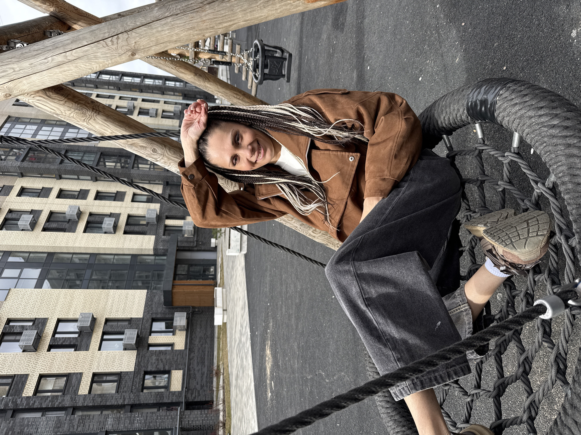 Woman enjoys playground swing in Rusanovo park