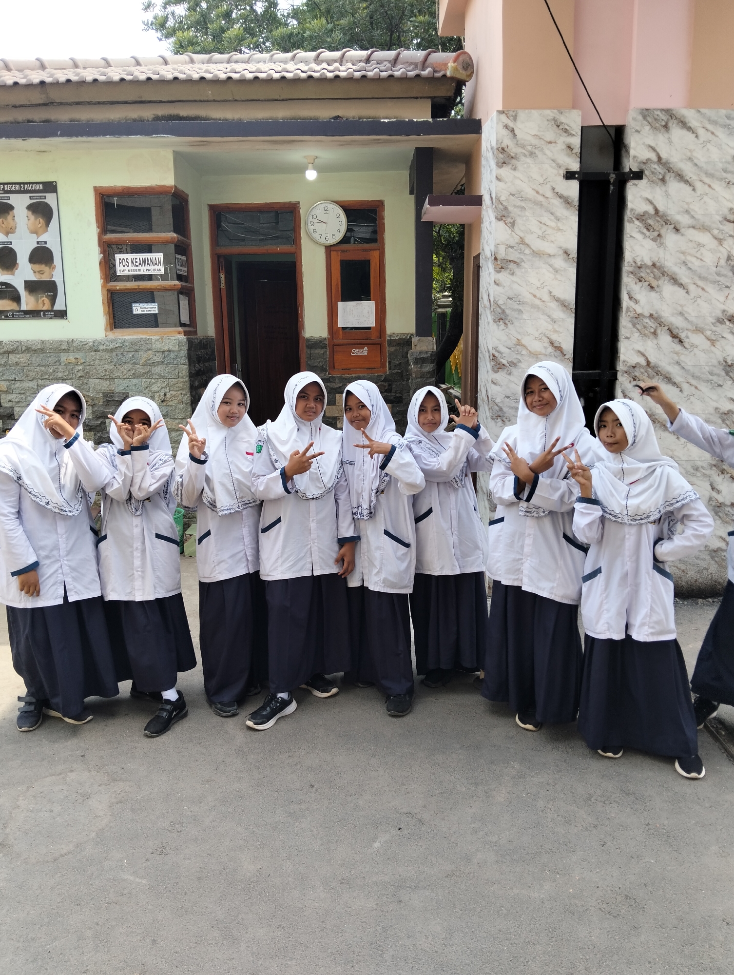 Students pose for photos outside a school in Paciran, Indonesia.