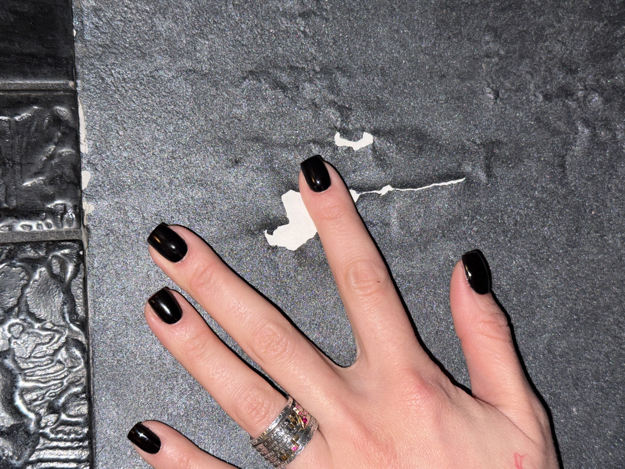 Hand with black nails, silver ring observed in Sofia