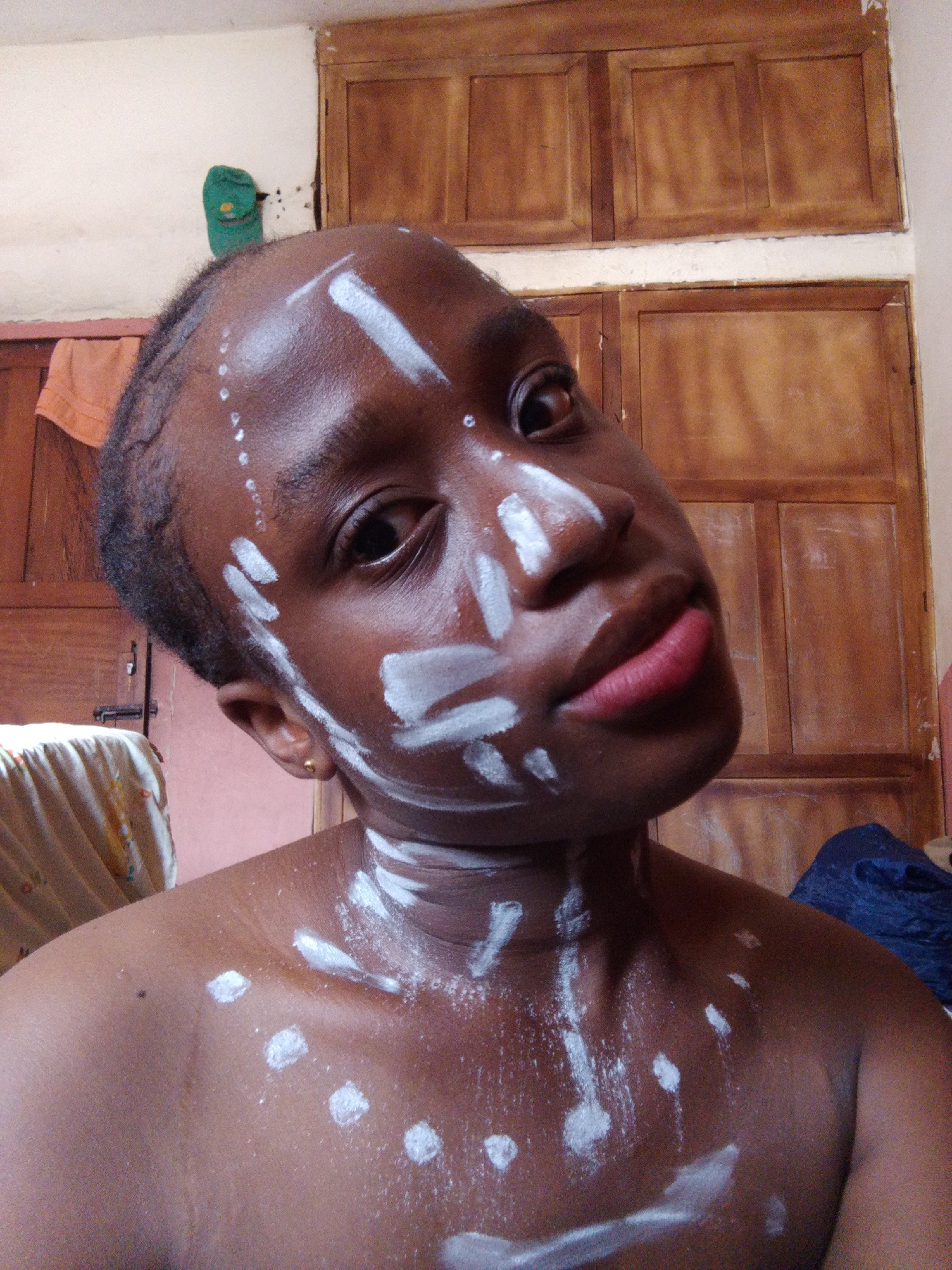 Person documents ceremonial face painting ritual in extended session