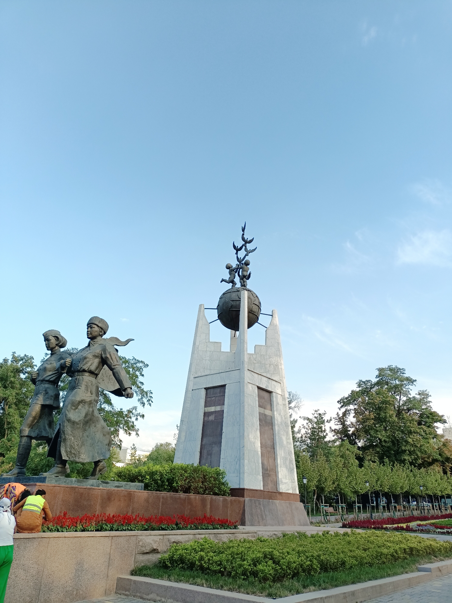 Strolling through a leafy Almaty park on a bright summer day