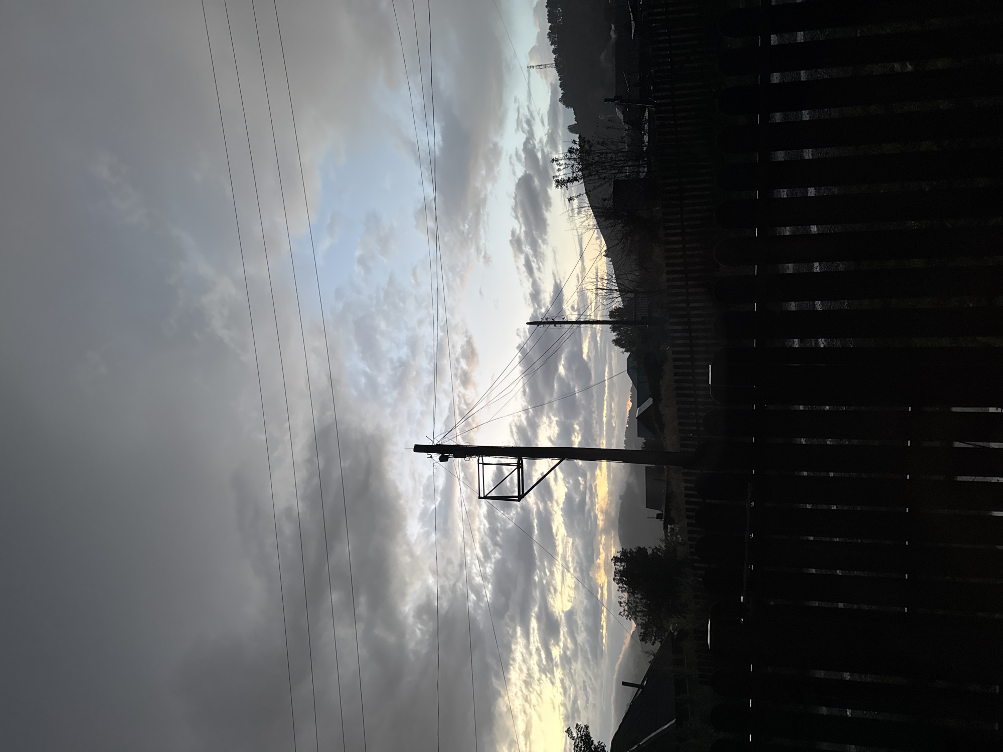 Dusk over a Russian village fence, with a paper flower inside