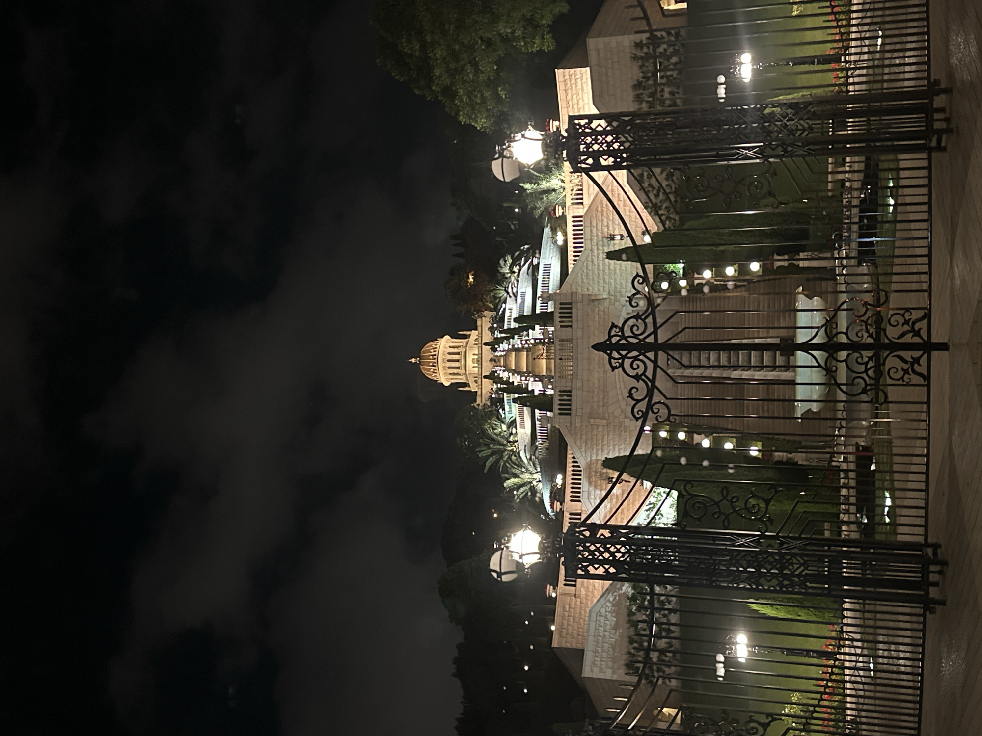 Baháʼí World Centre lit up after dark in Haifa