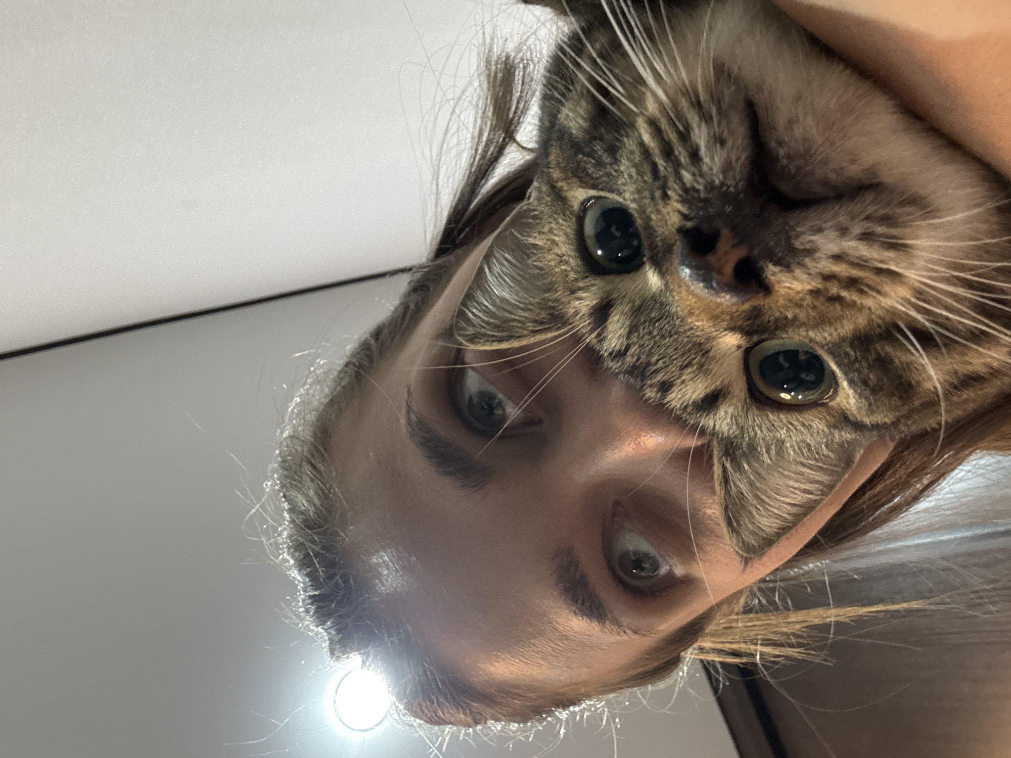 Woman and tabby cat share quiet moment in Chernushka