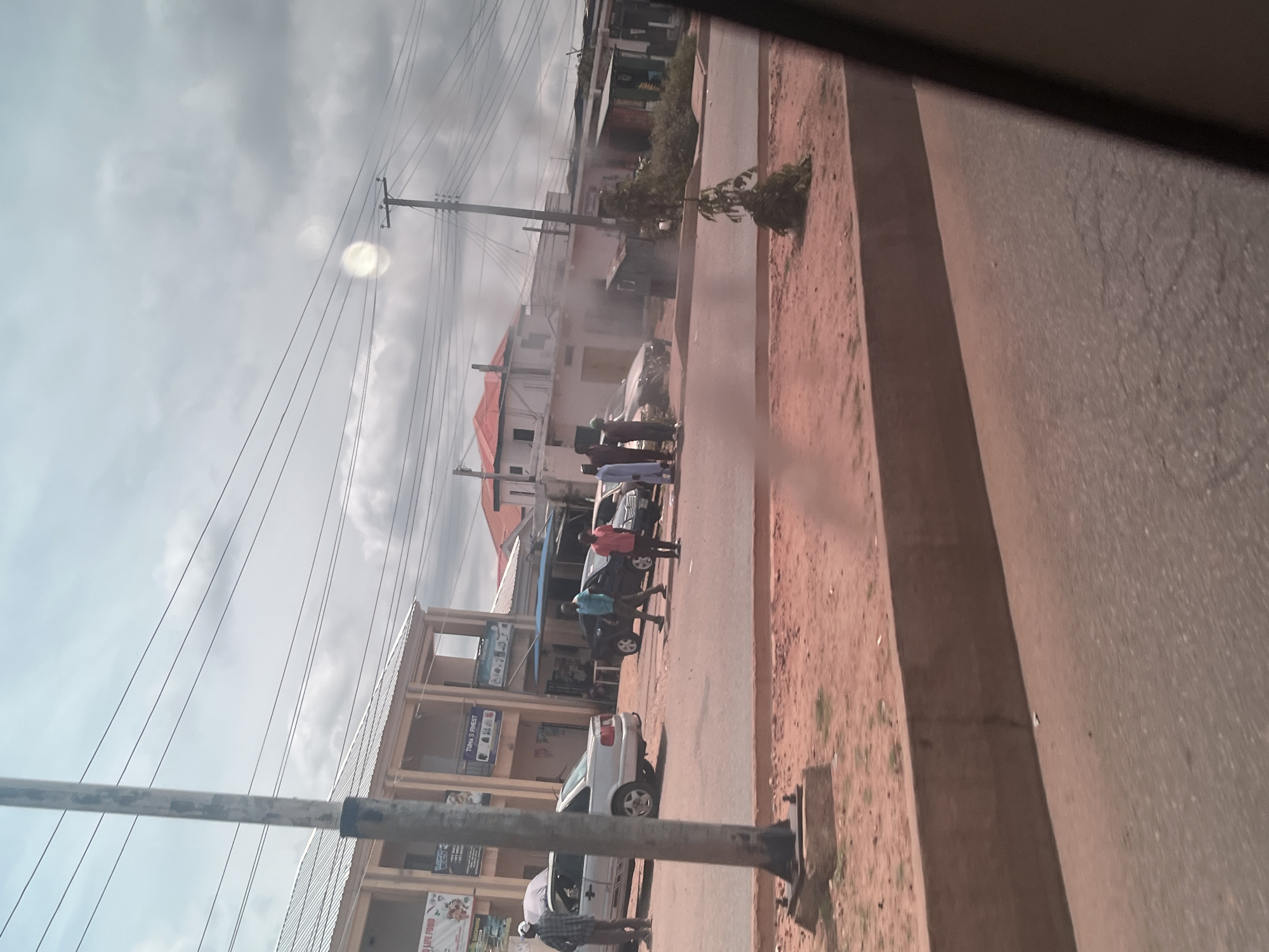 Roadside scene along a paved street in Bukuru, Nigeria