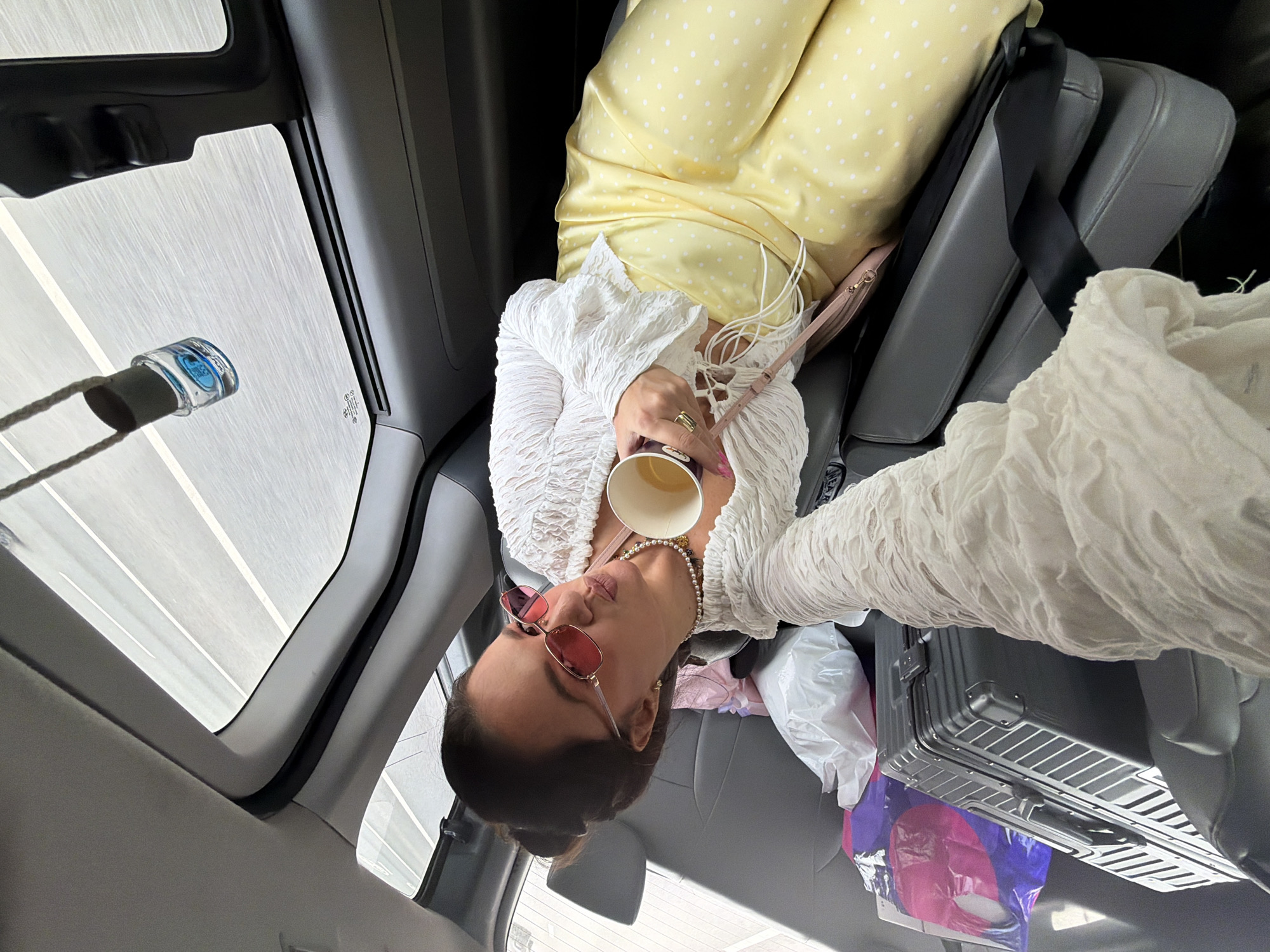 Chilling in the back seat, paper cup in hand, Khimki