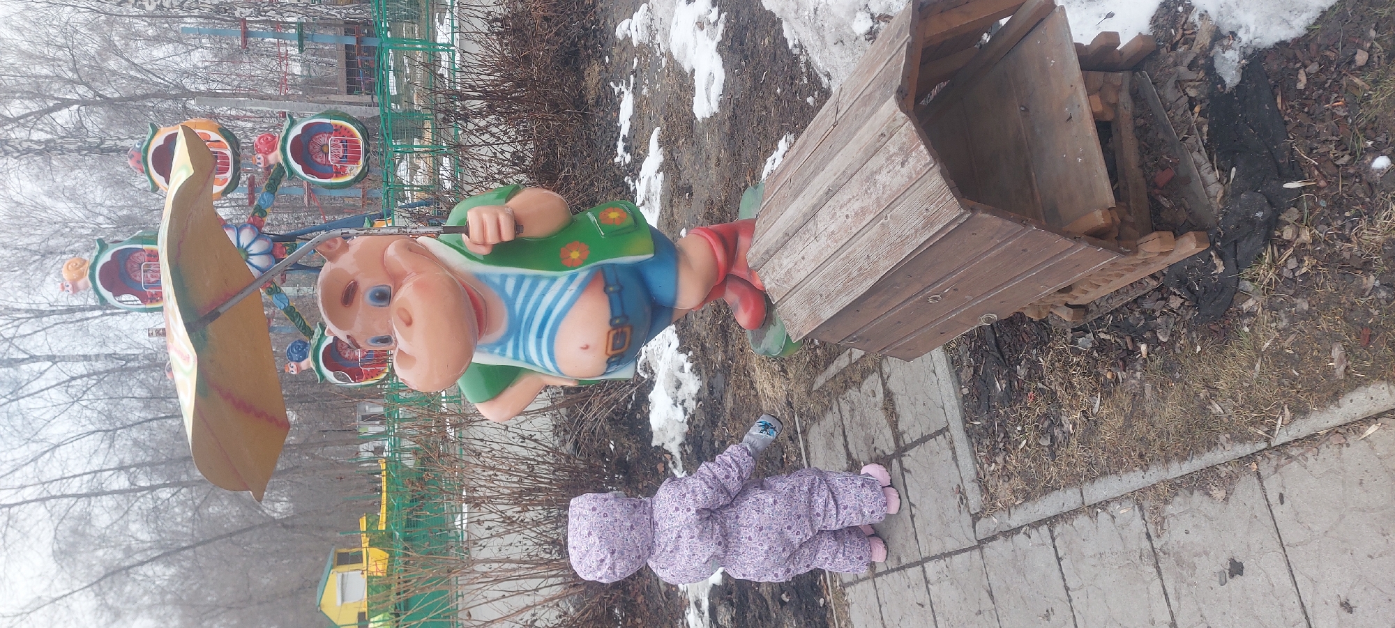 Winter park scenes documented in Novosibirsk featuring child, statues