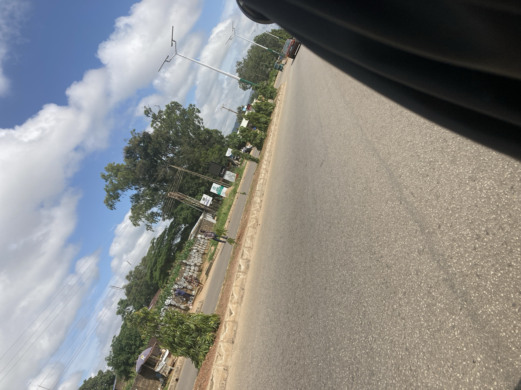 Jos roadside: traffic, construction, and tree-lined streets