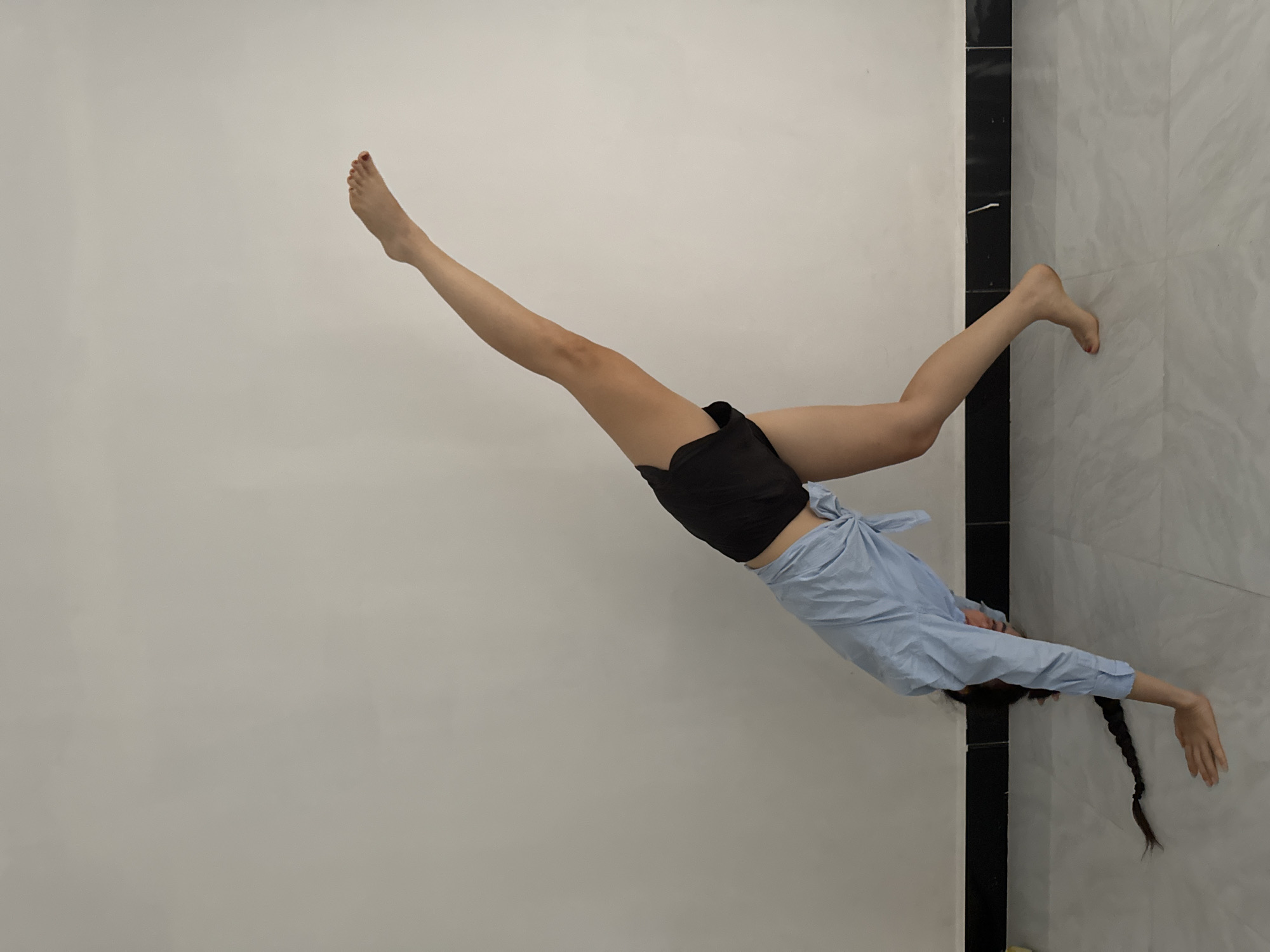 Person captured in dynamic inverted pose in Mũi Né