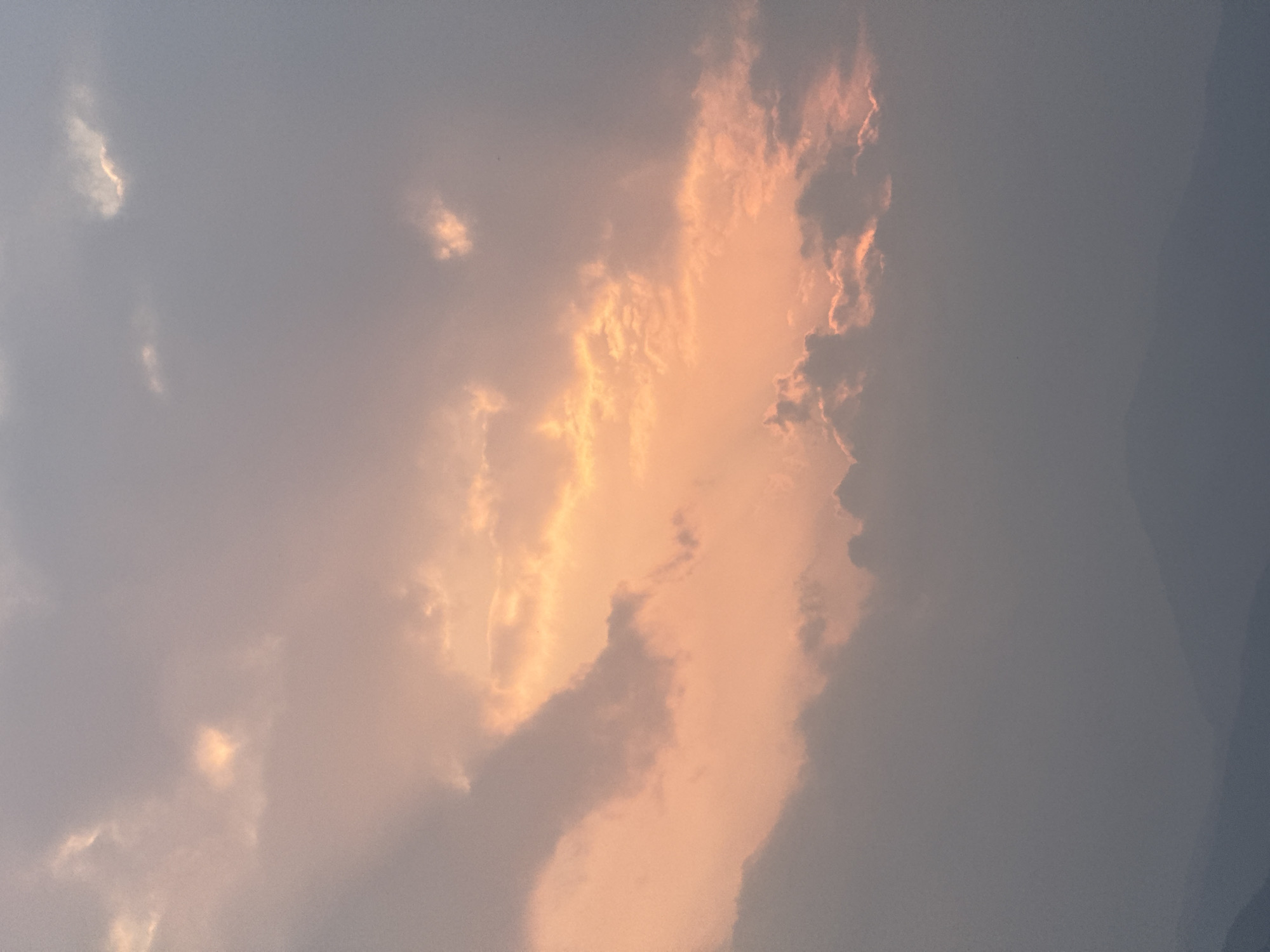Sunset illuminates clouds and grassland in Pokhara, Nepal