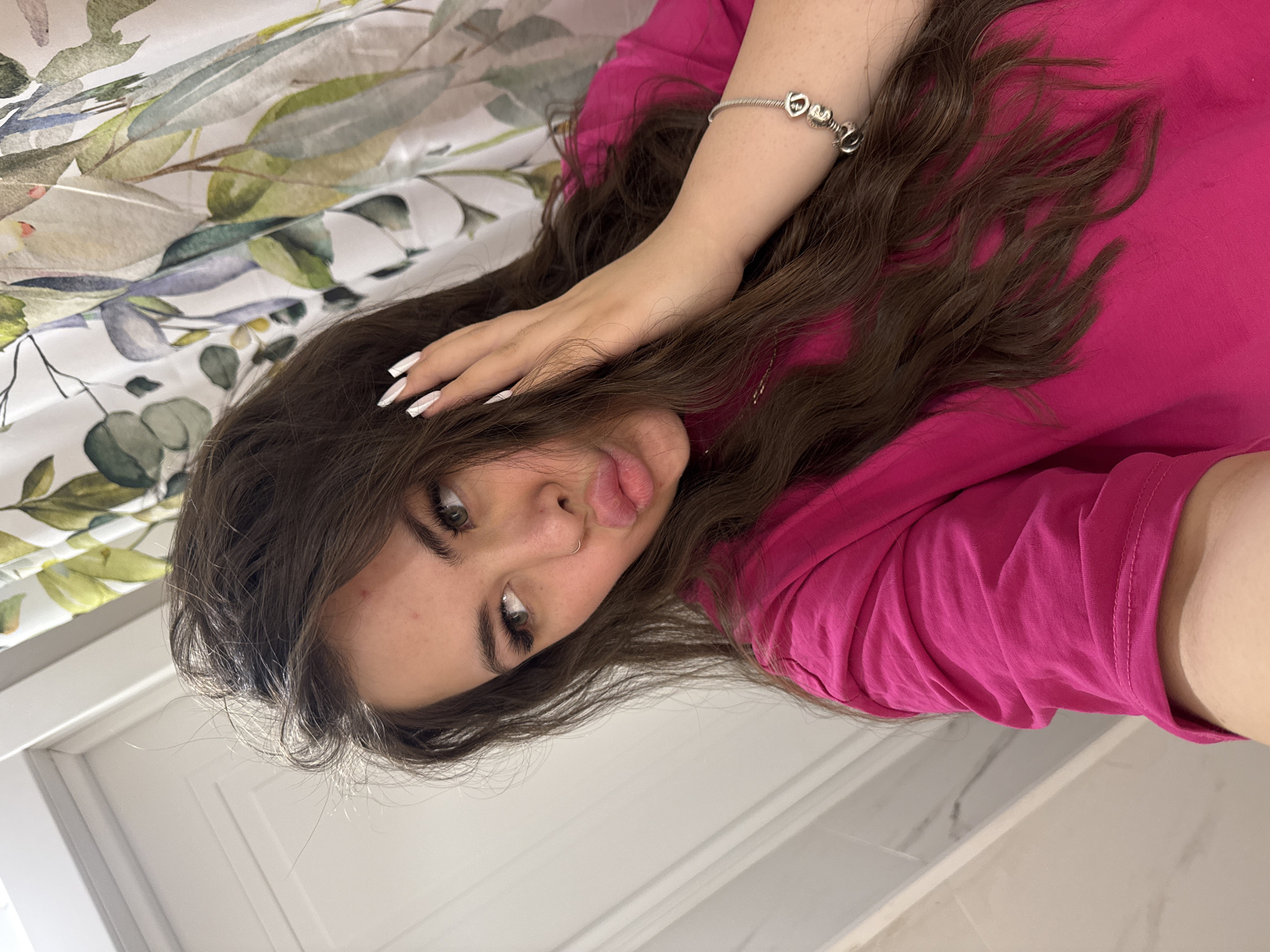Young woman takes playful selfie indoors in Russia