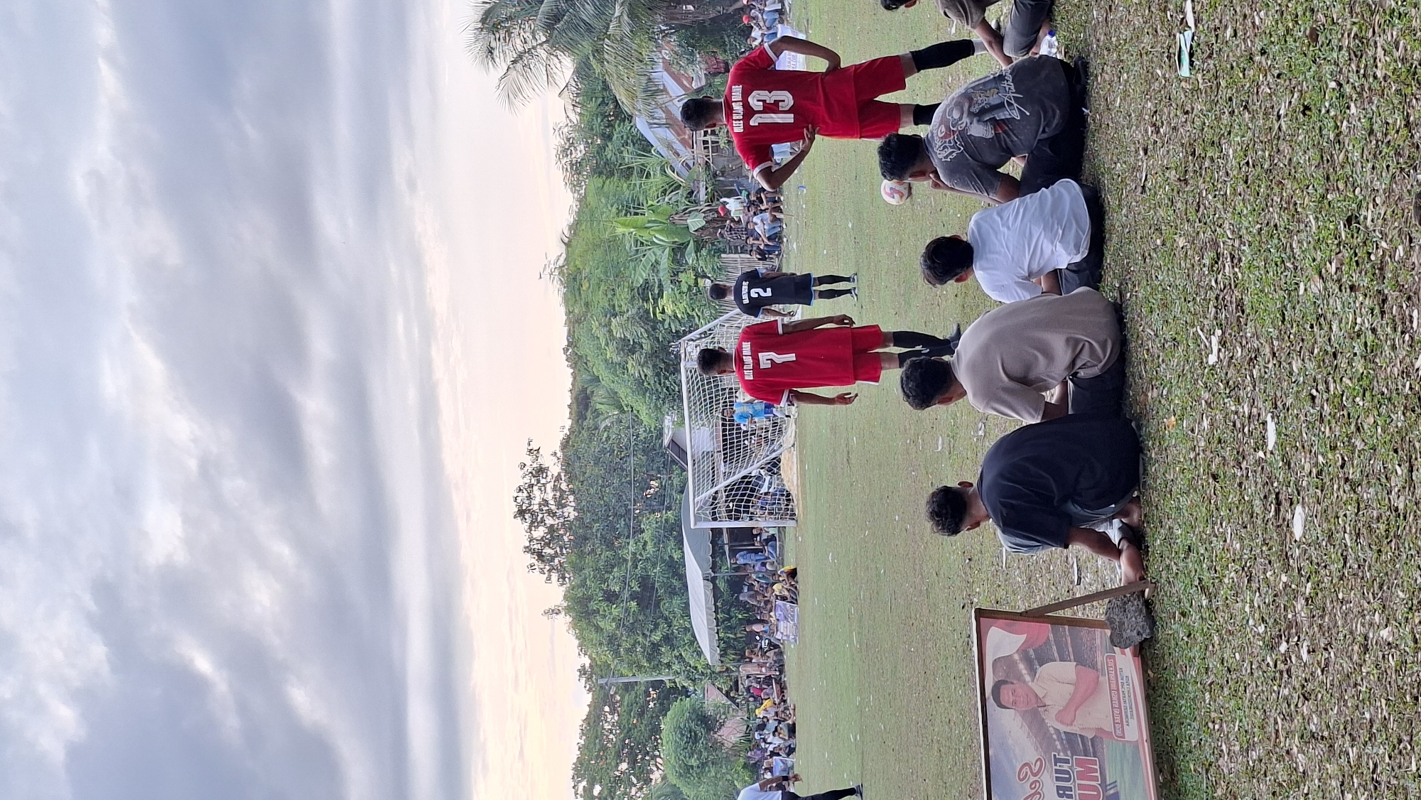Local soccer match underway in Lhokseumawe with crowd watching