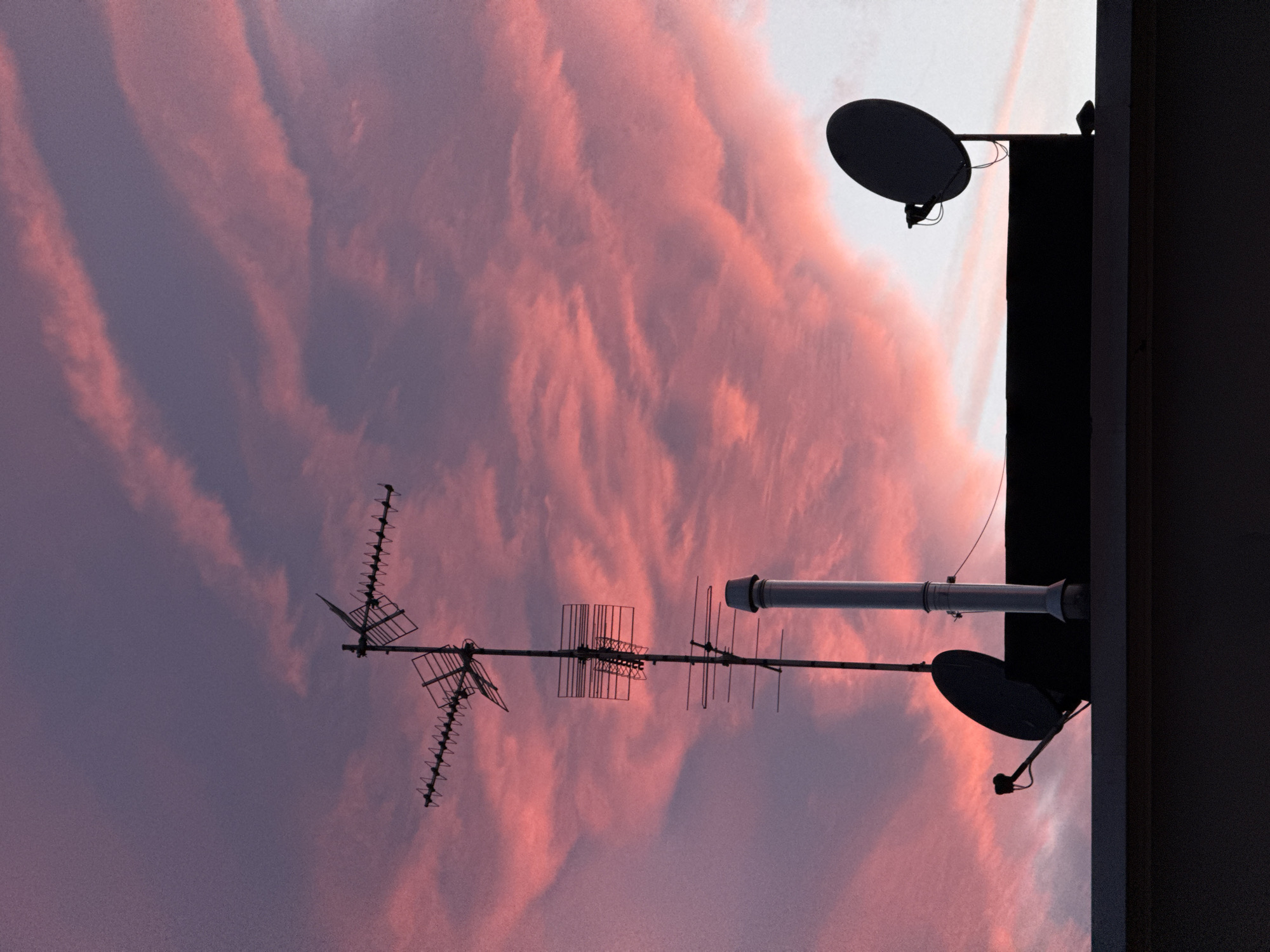 Milan rooftop skyline at golden hour, July evening