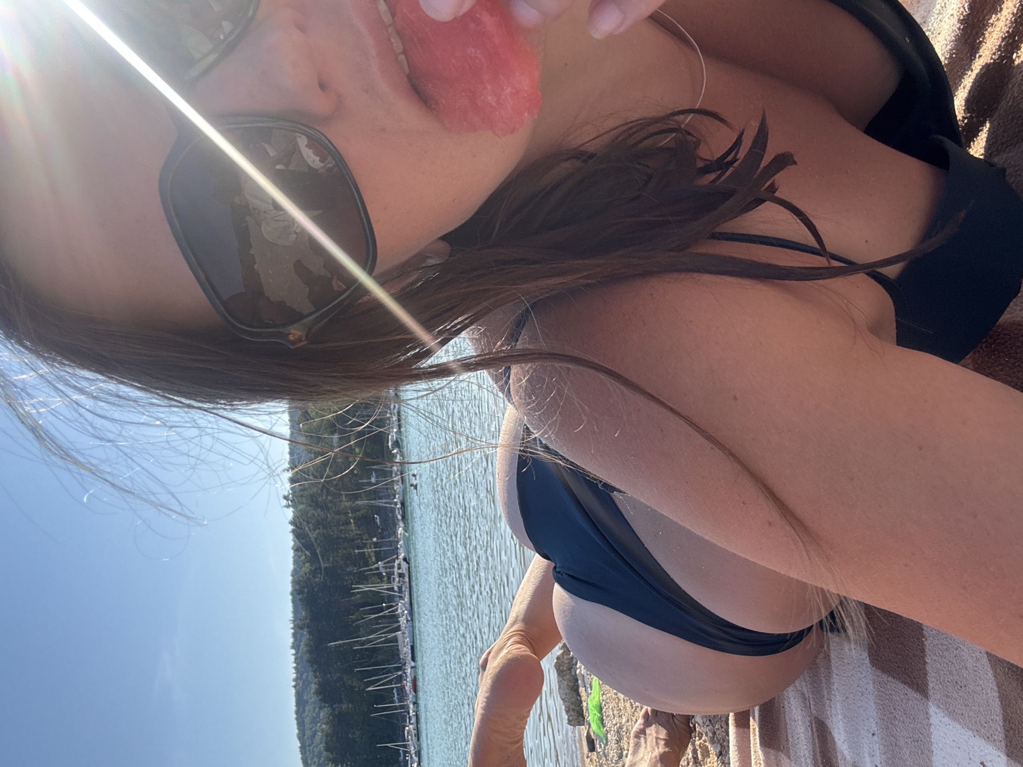Watermelon and sunshine on a calm French lakeside beach