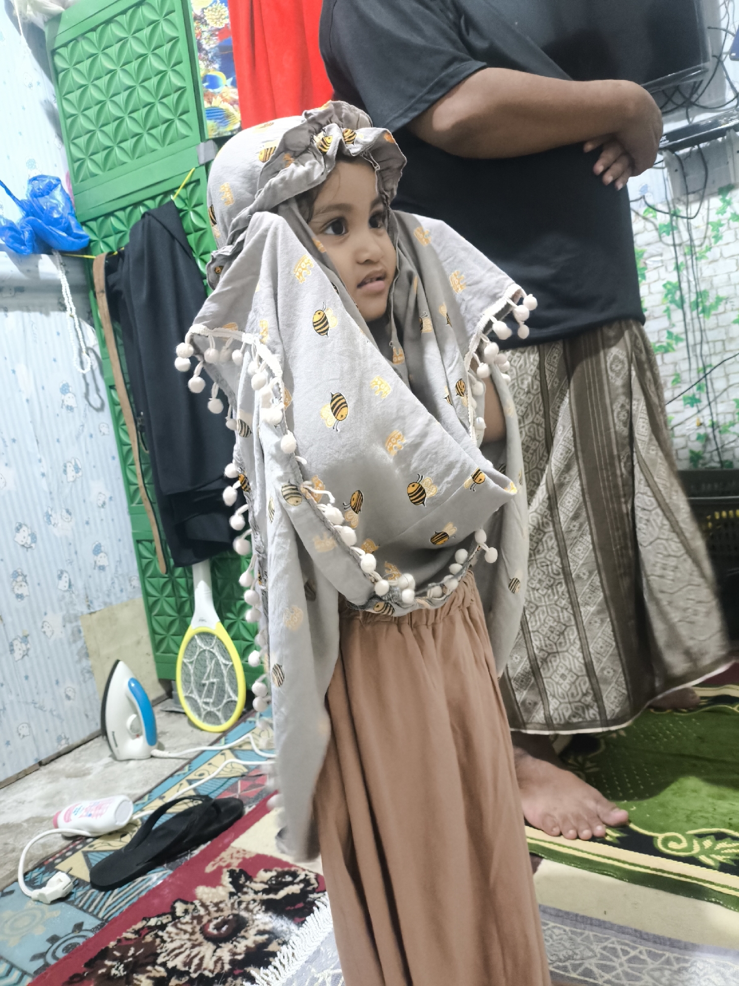 Bee-patterned hijab and pom-poms in Blangseureukuy, Indonesia