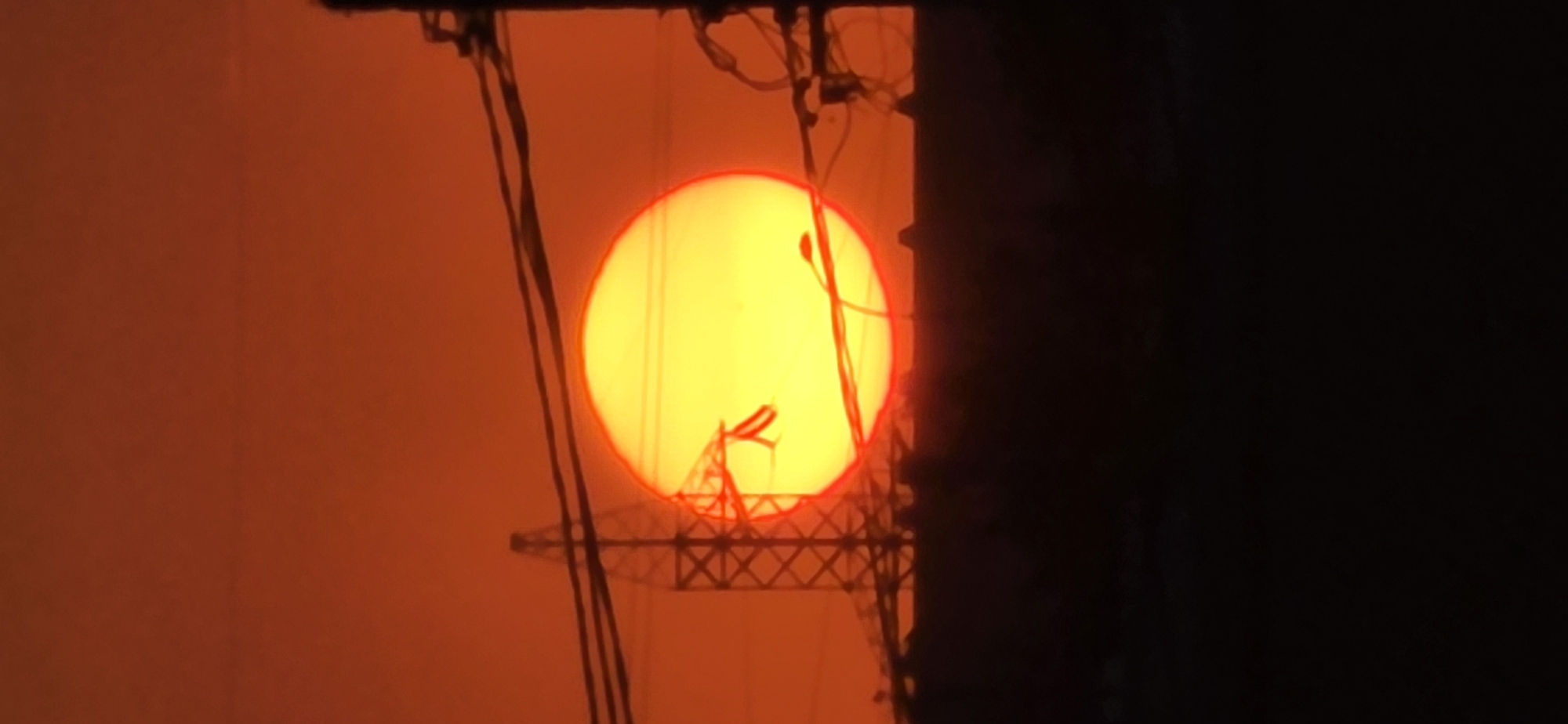 Warm sunset glow over Tashkent's skyline and wires