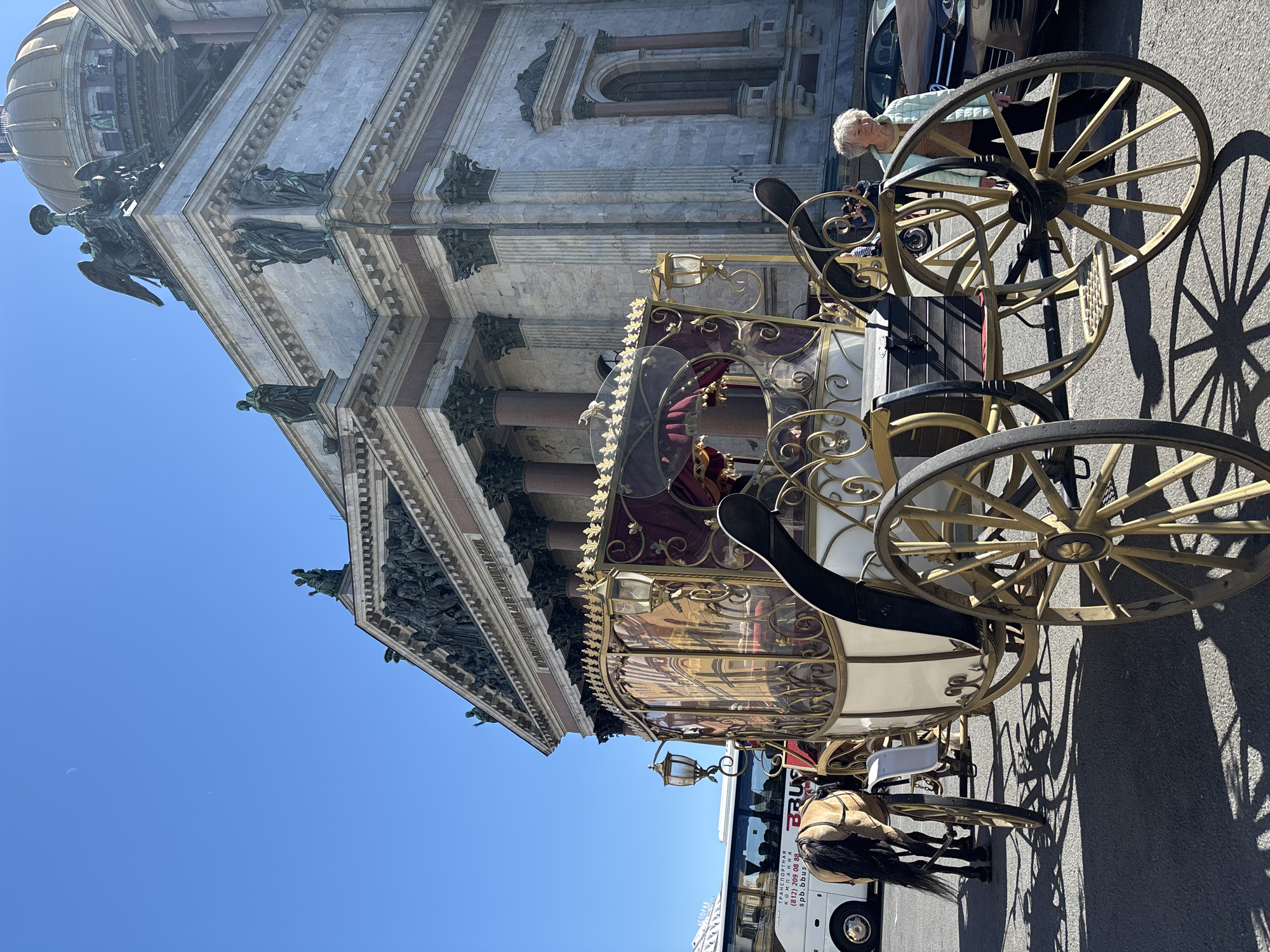 Horse-drawn carriage near Saint Petersburg's landmark cathedrals on a sunny afternoon