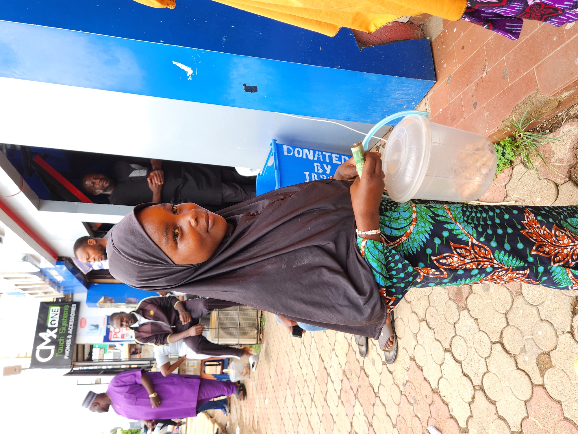 Street vendors and delivery workers observed during midday commerce