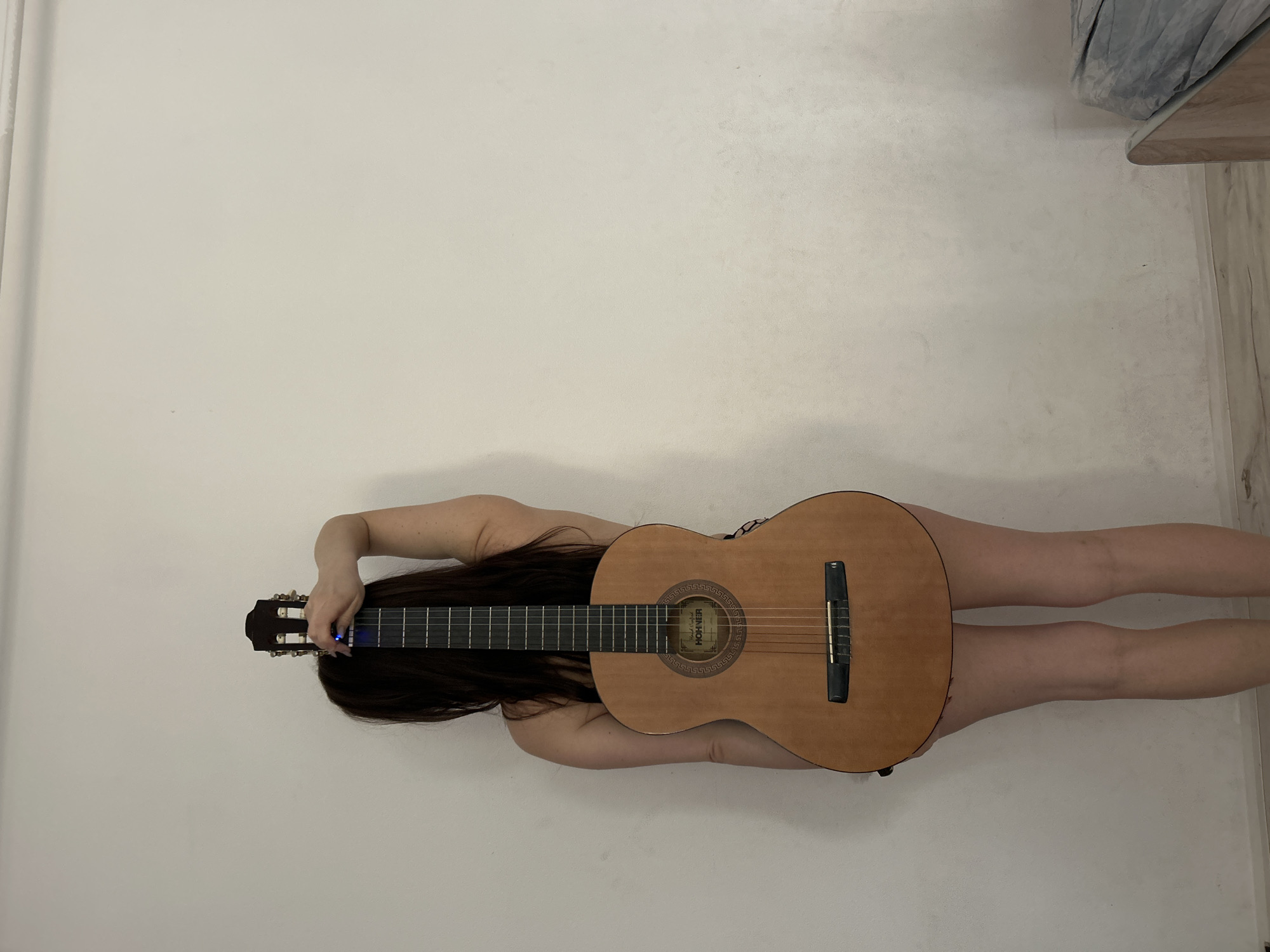 Woman poses with guitar in artistic photo session, Rusalevka
