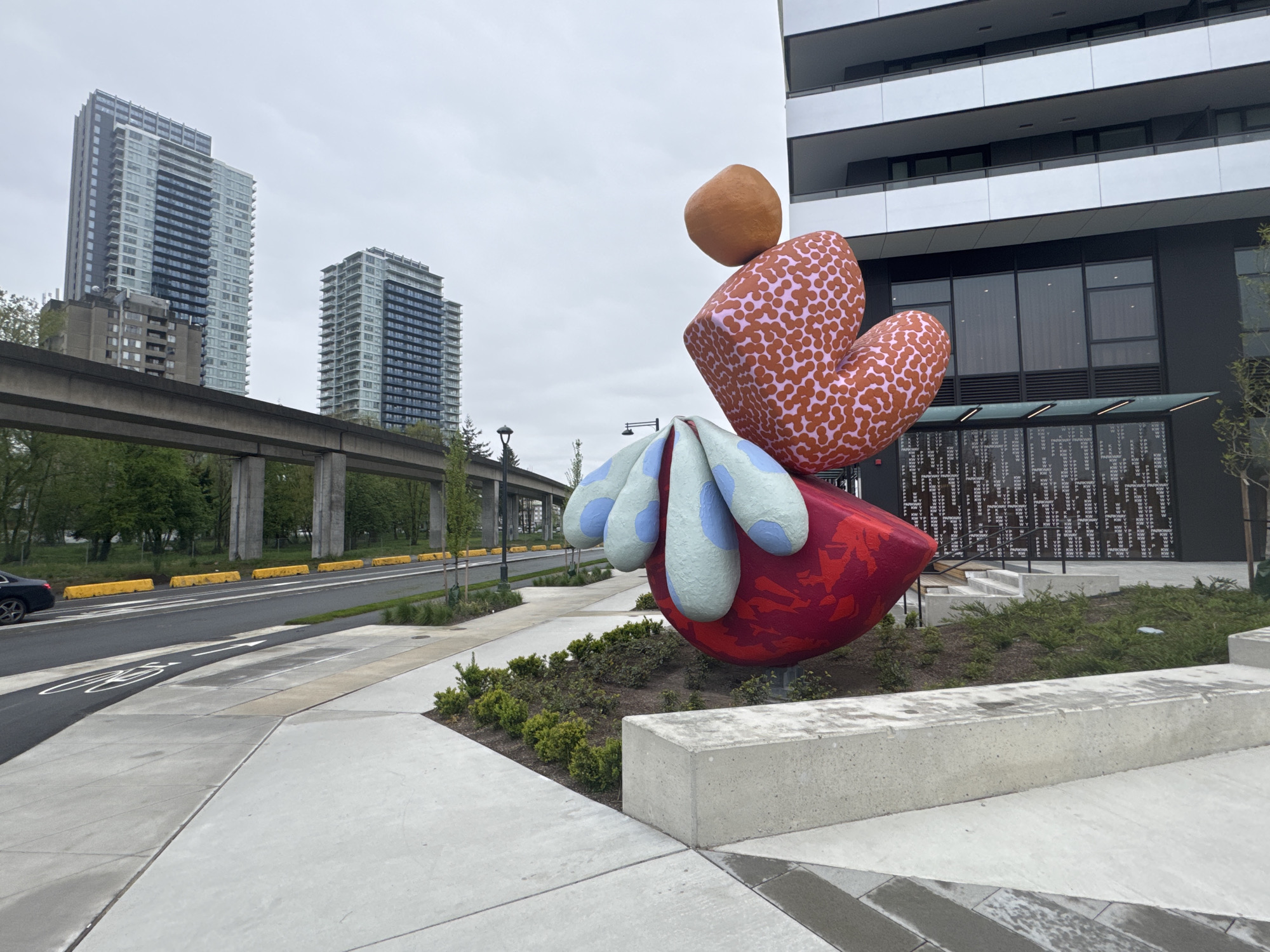 Surrey plaza with abstract sculpture captured during spring overcast