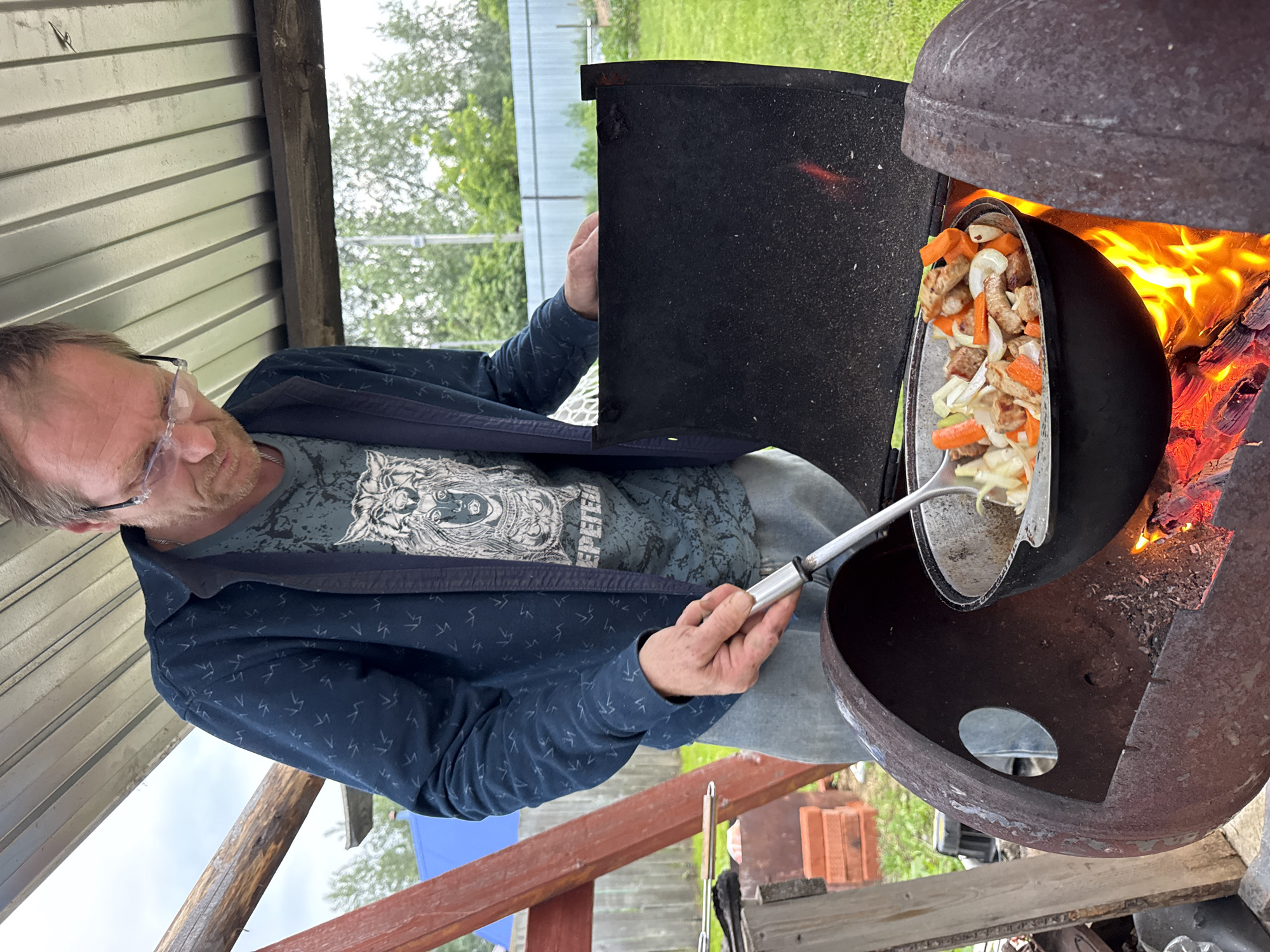 Outdoor pot cooking under a canopy in Chaikovsky, Russia