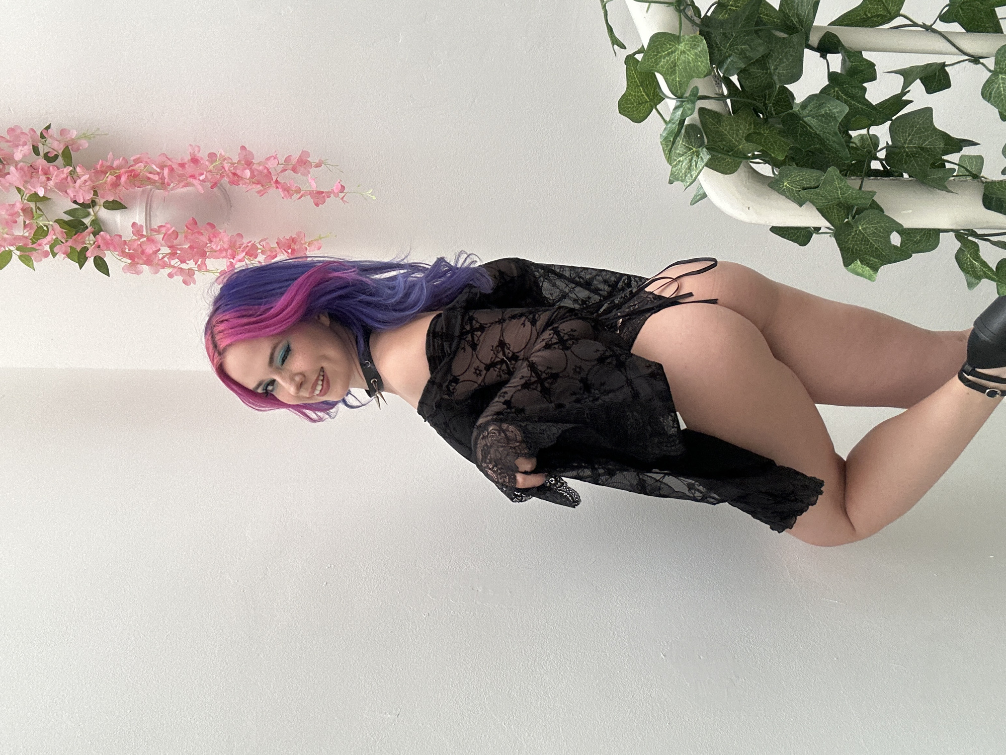 Young woman with vibrant hair poses for indoor portrait session