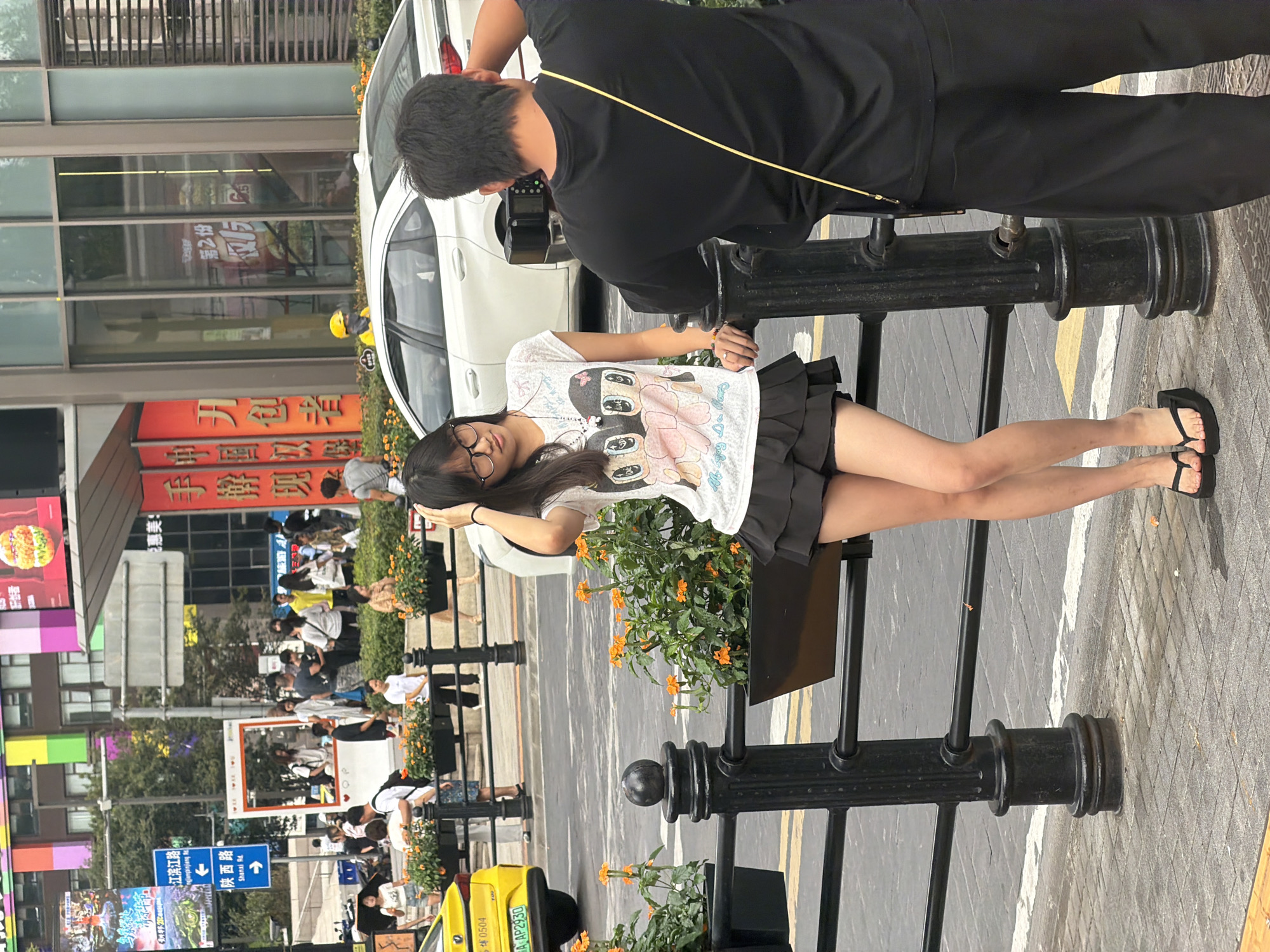 Pedestrians moving through a Yuzhong District sidewalk, August morning