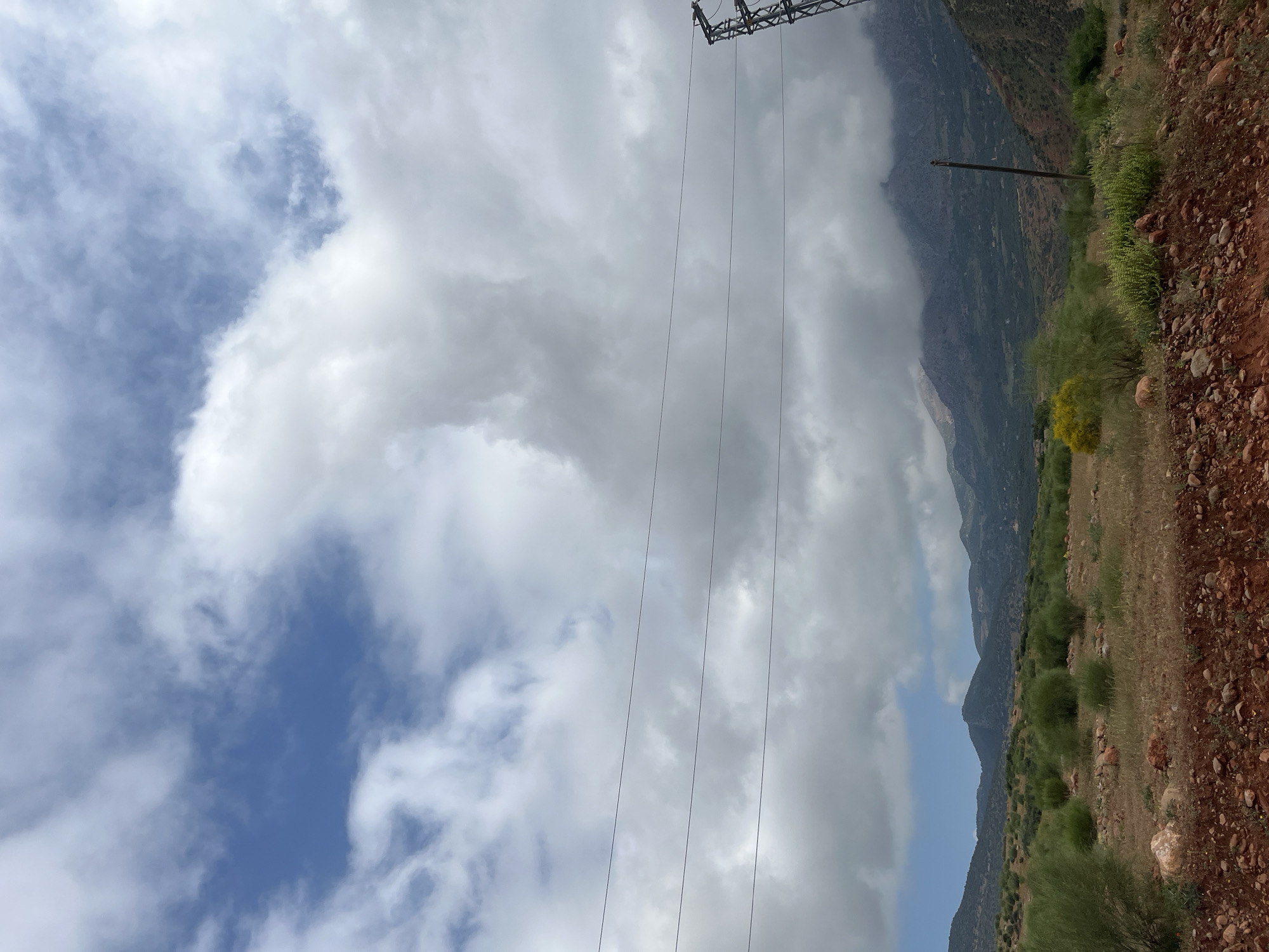 Workers service power lines in rural Morocco landscape