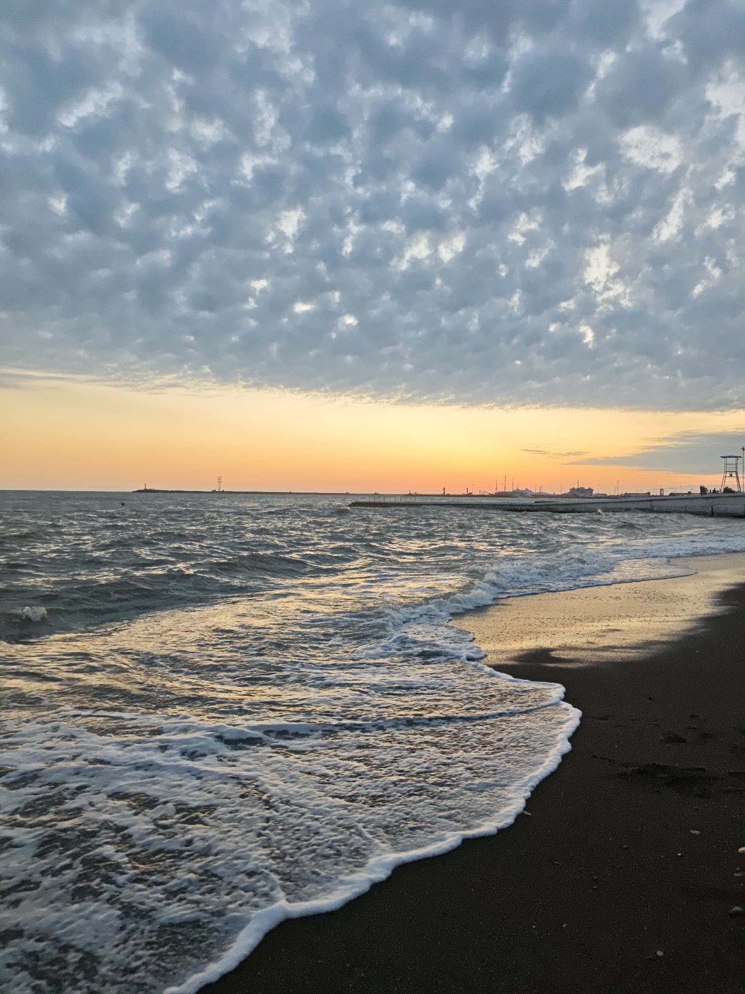 Woman in pink explores Sochi beaches and parks during sunset