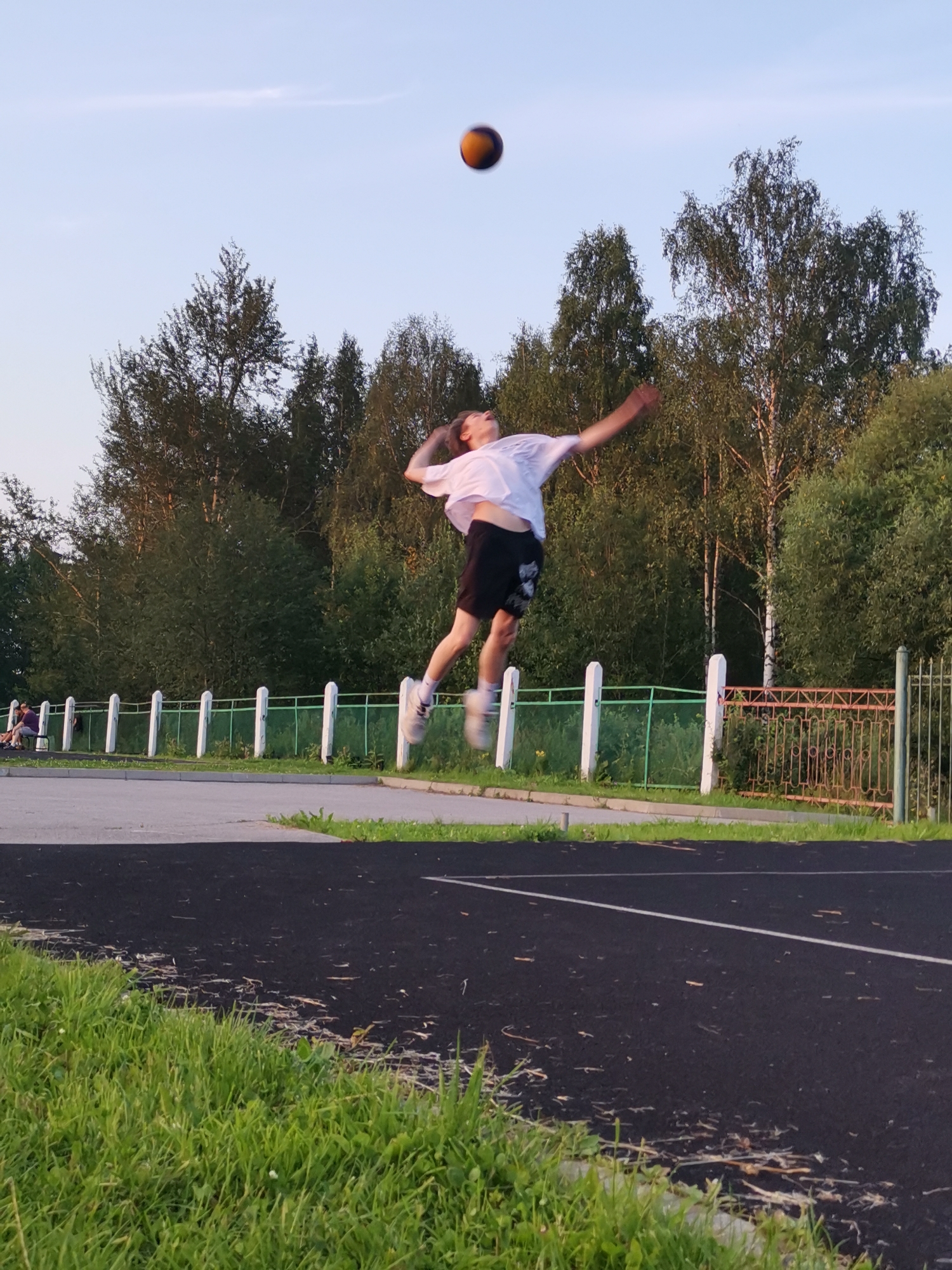 Pickup volleyball on an outdoor court in Kizel at dusk