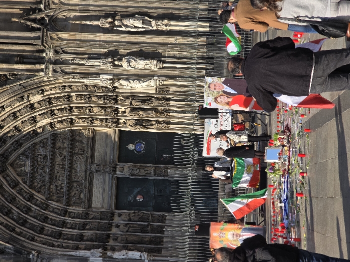 Flag-carrying demonstrators gather at Cologne Cathedral in afternoon protest