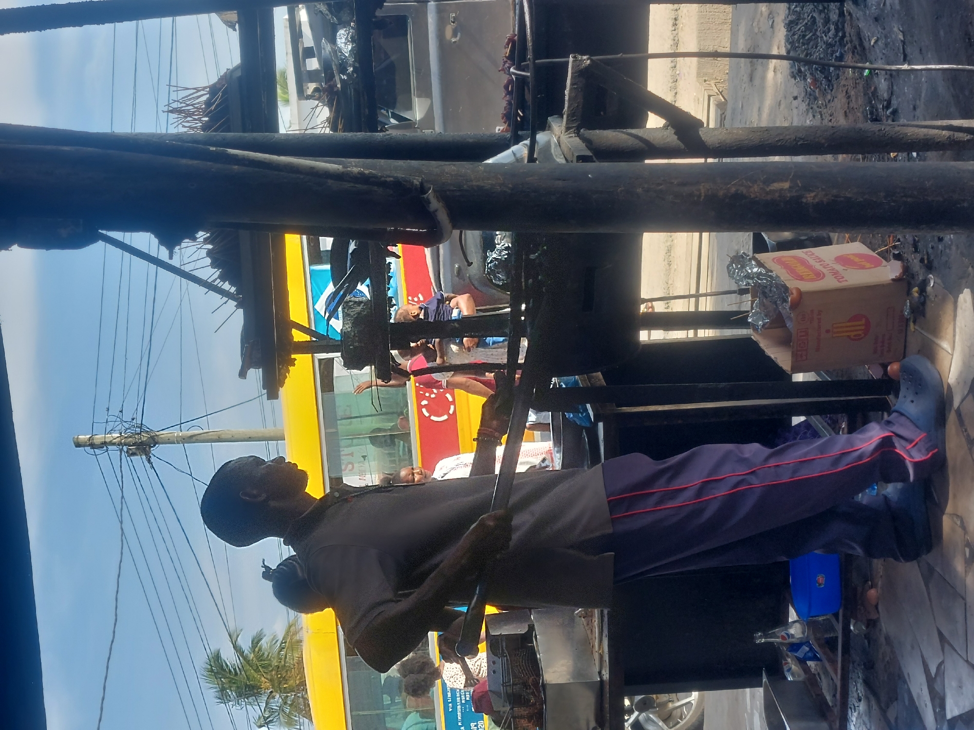 Street food vendors serve customers at roadside eateries in Dar es Salaam