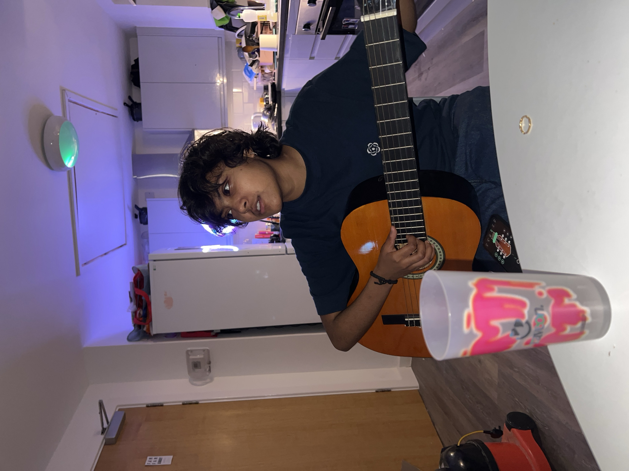 Late night apartment gathering features guitar music and photos