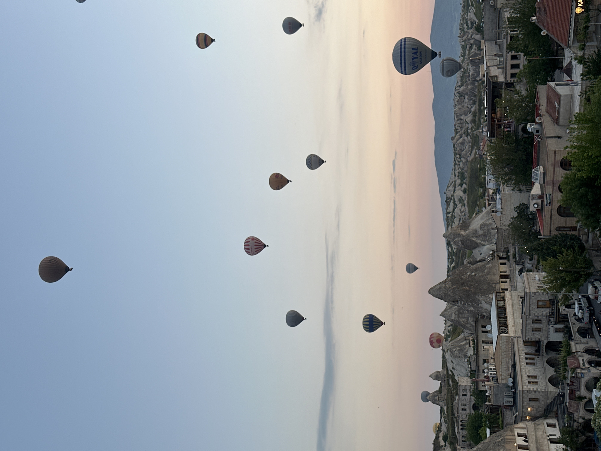 Hot air balloons rise over Cappadocia at sunrise