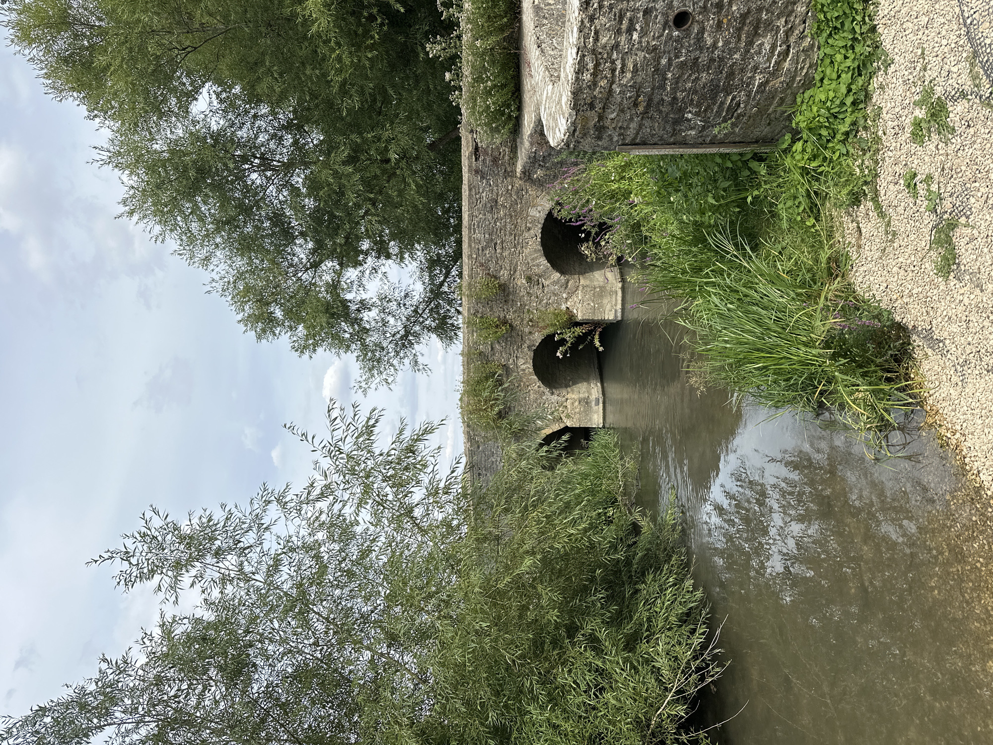 Exploring Minster Lovell's ruins, river, and church on a cloudy afternoon