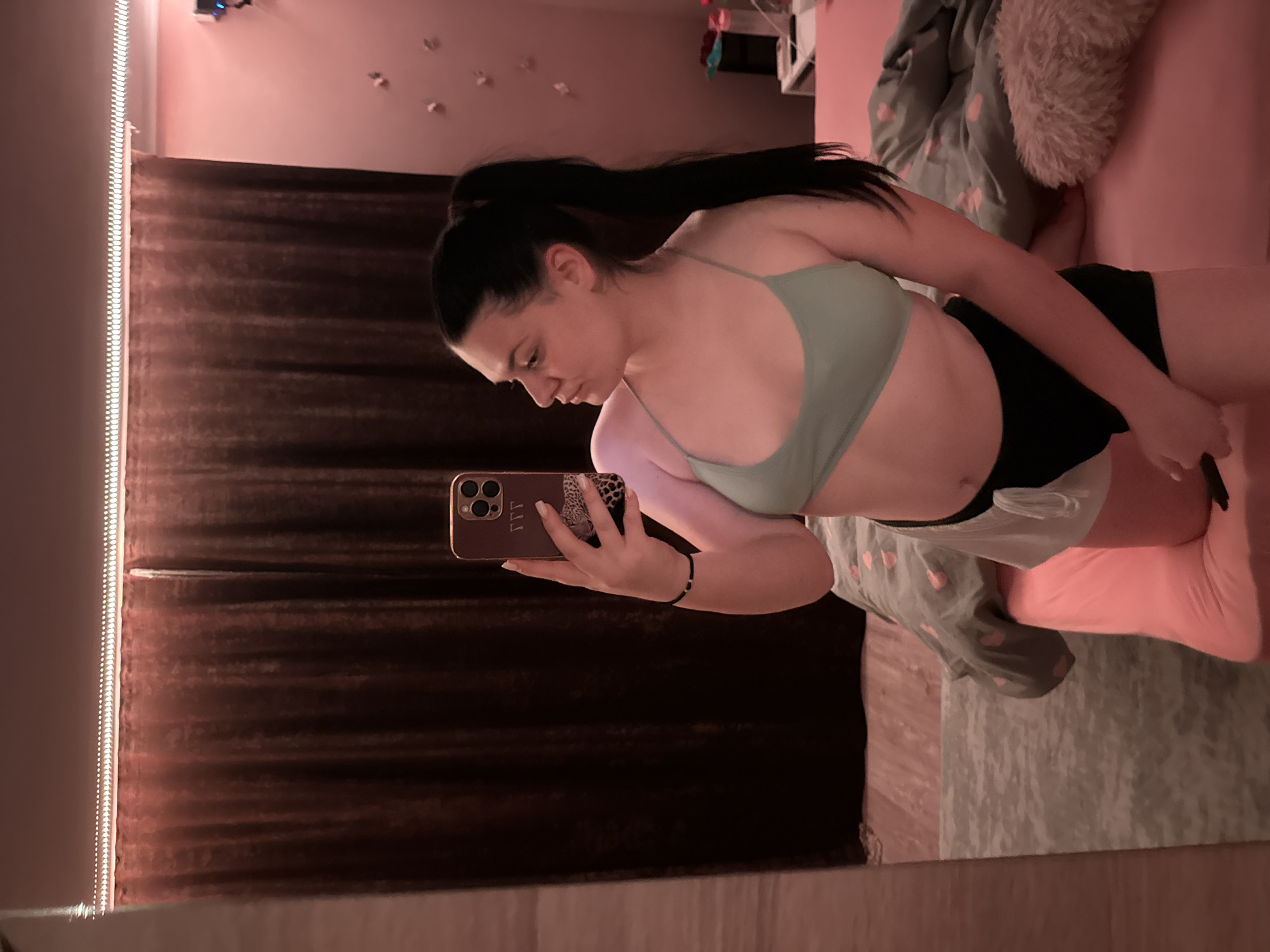 Woman takes mirror selfies in bedroom in Rogosh, Bulgaria