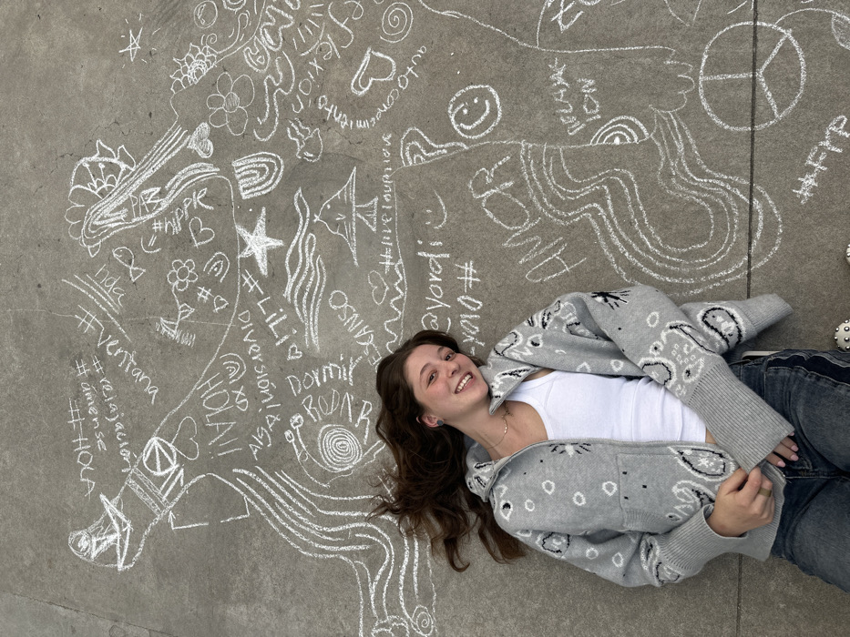 Young artists create nighttime chalk art in concrete courtyard