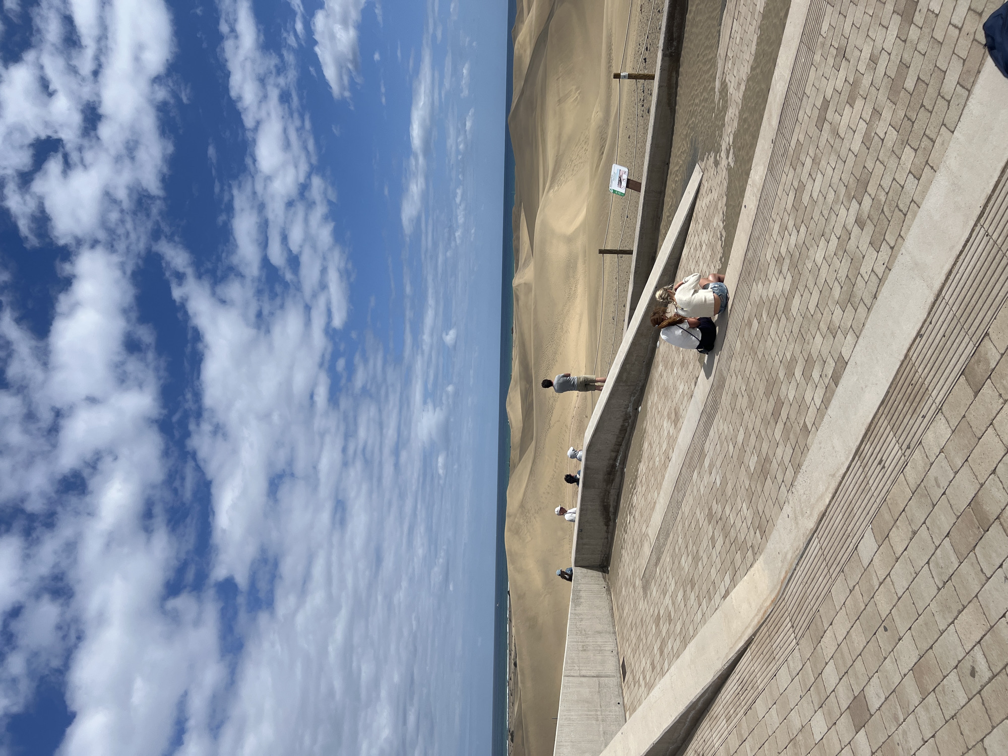 Visitors gather at coastal viewing area in Gran Canaria