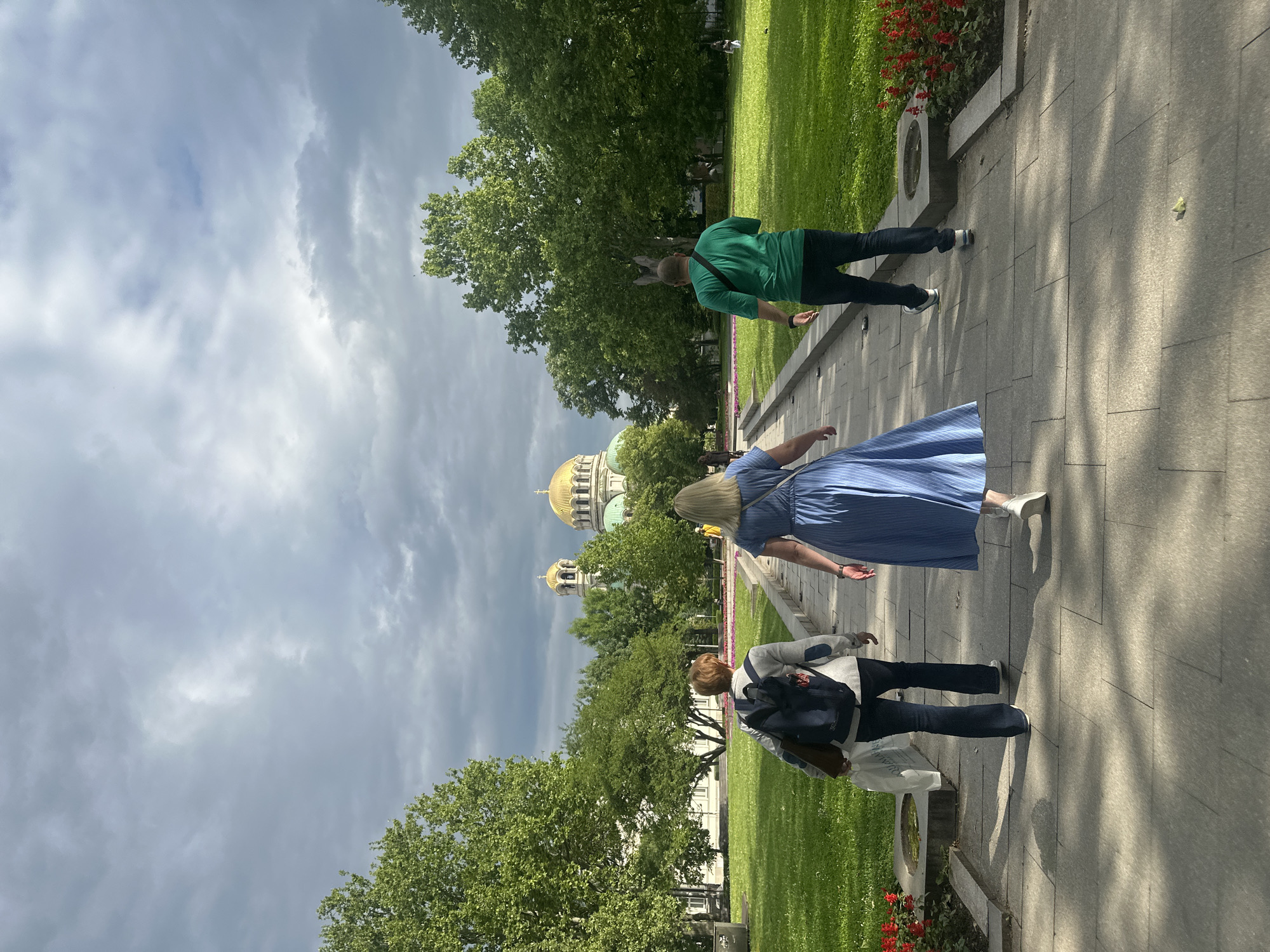Morning pedestrians captured walking through Sofia park near monument