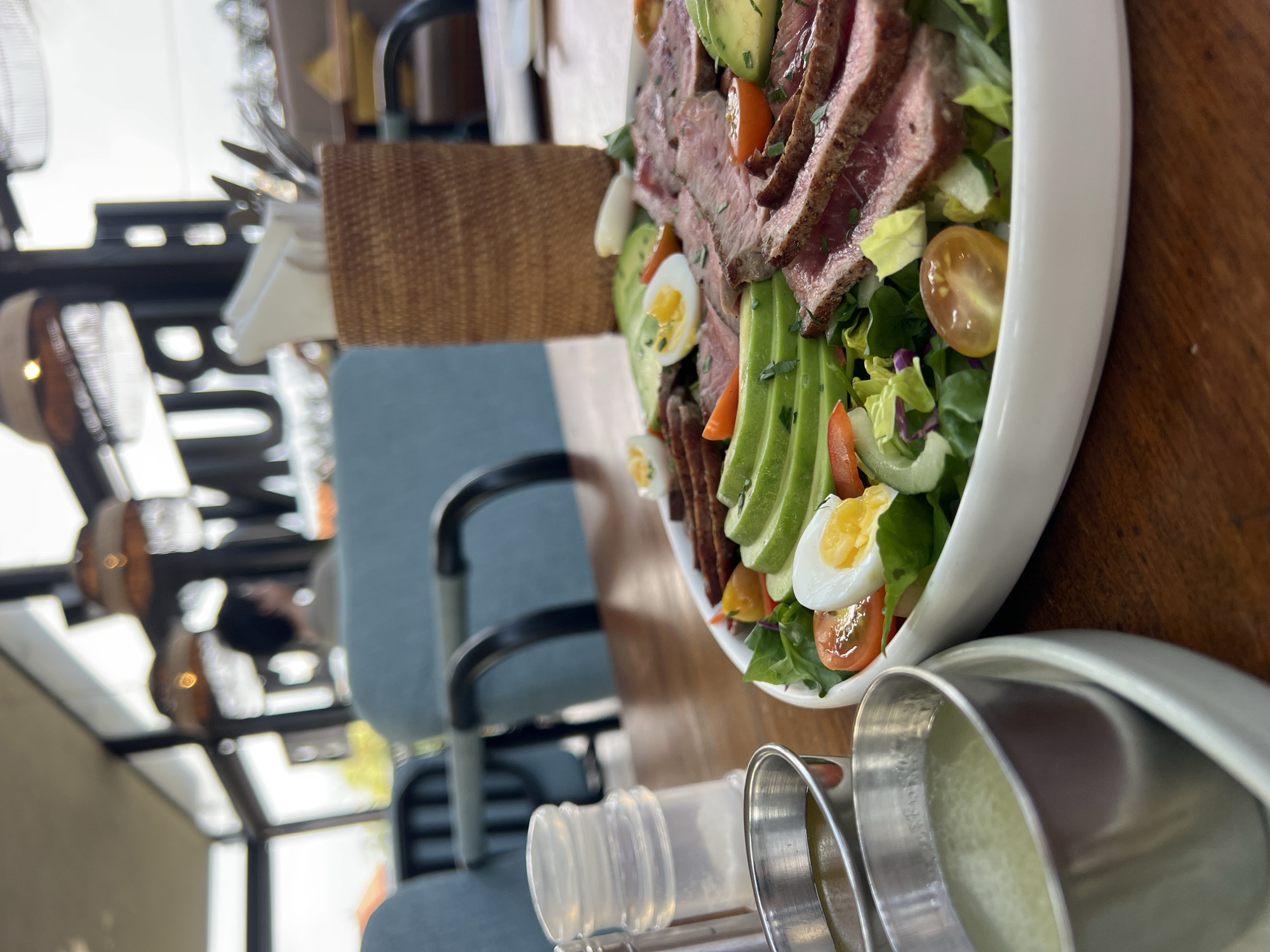 Brunch at a tropical Mengwi cafe with food and a relaxed dog