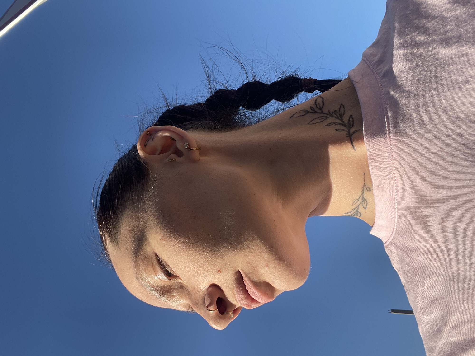 Woman with braided hair, piercings observed in Pervomaysky