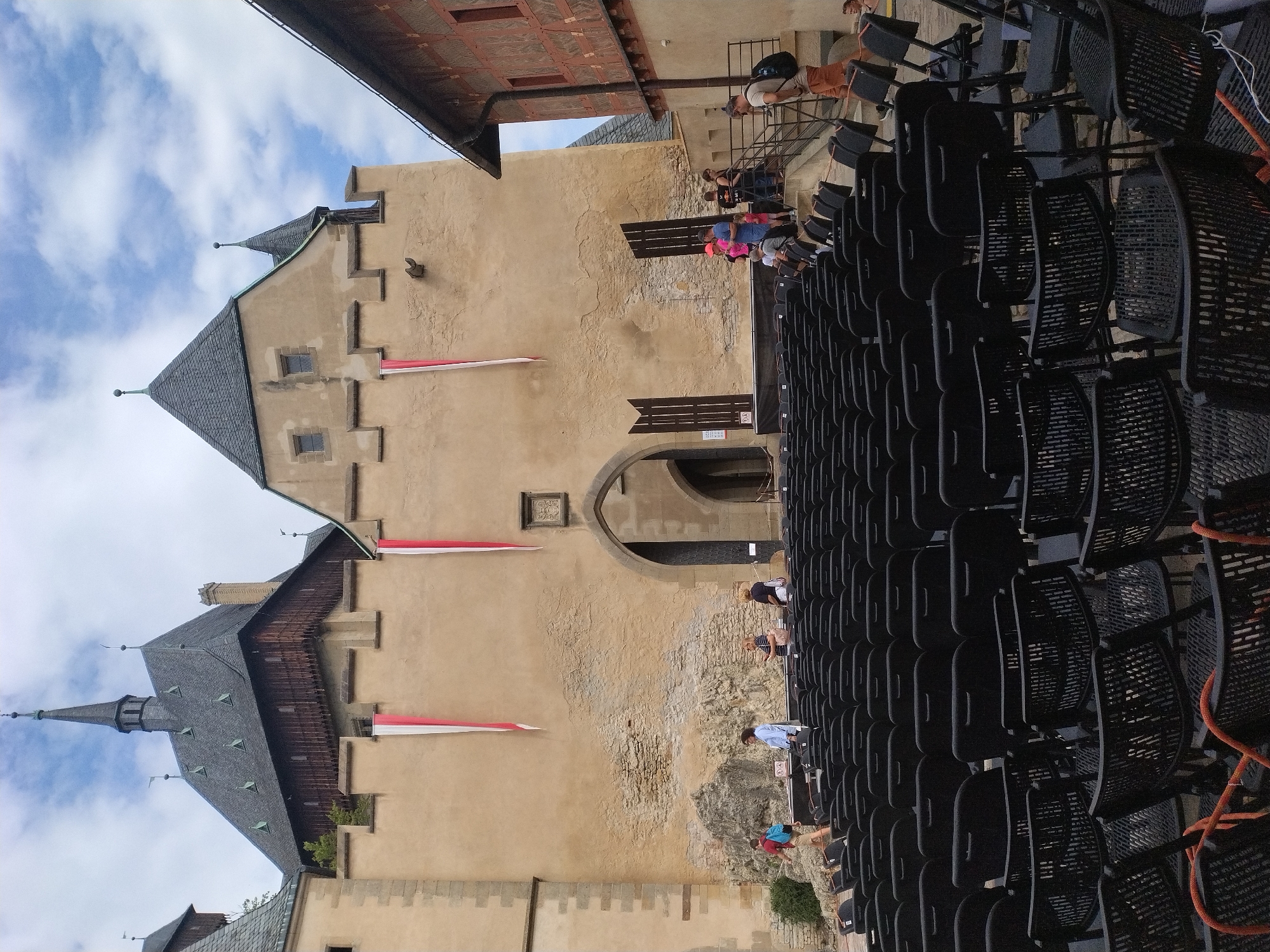 Karlštejn Castle courtyard busy with visitors and event prep