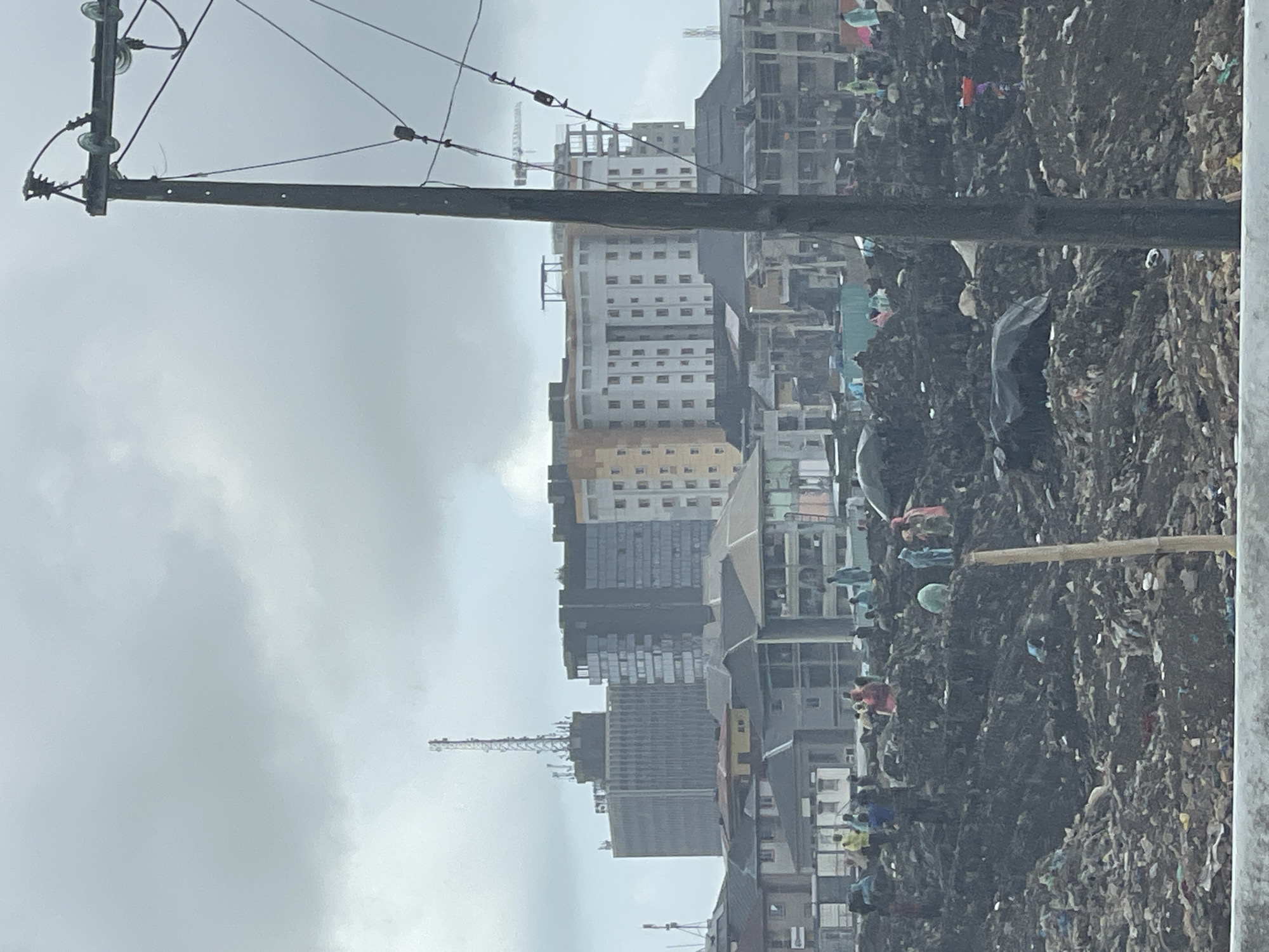 Lagos cityscape documented showing urban contrasts, scavenging activity