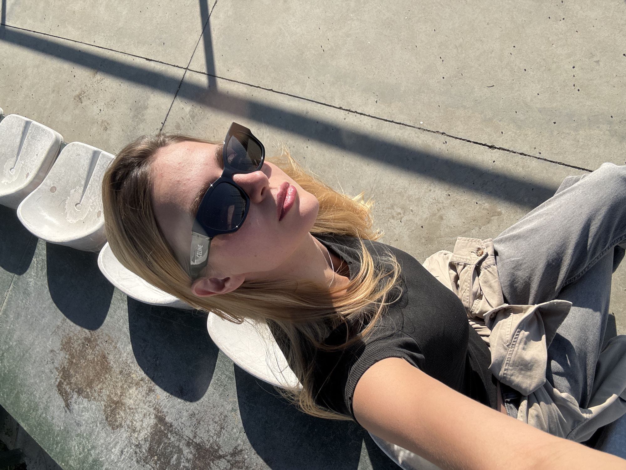Woman takes selfies at Dinamo Arena on sunny day