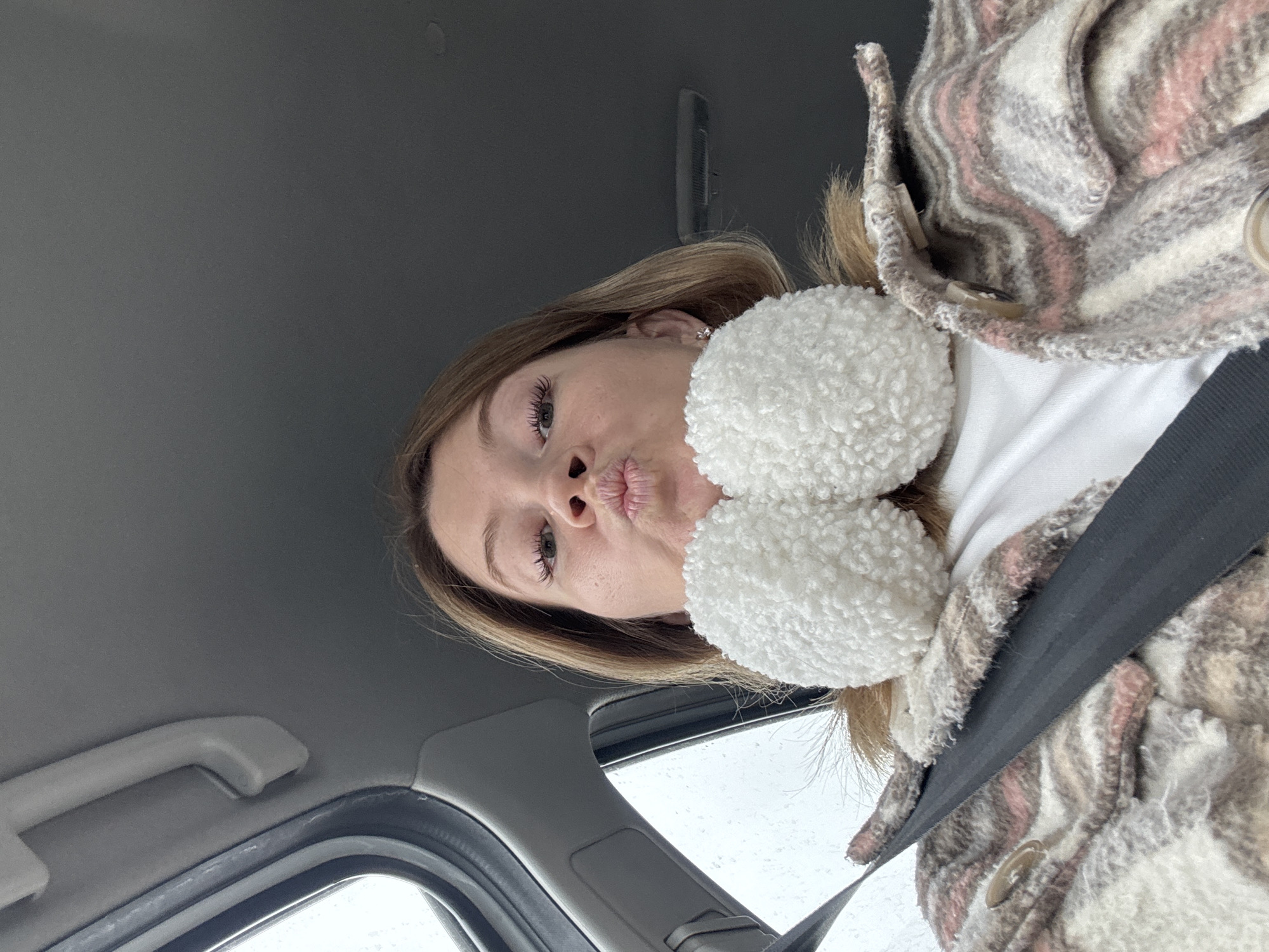 Woman photographed in vehicle wearing earmuffs in Foteni, Russia