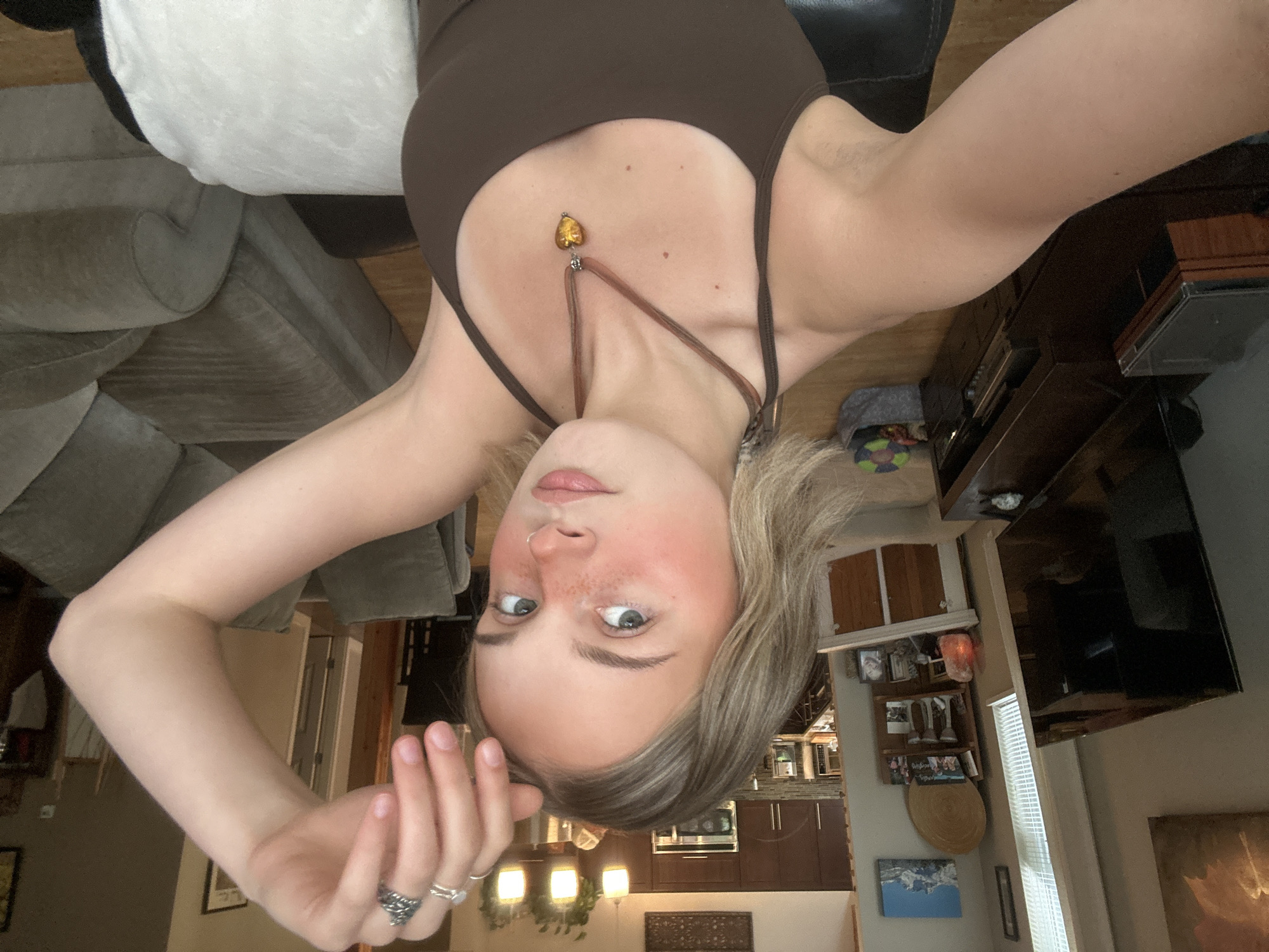 Woman takes selfies on couch in Whistler