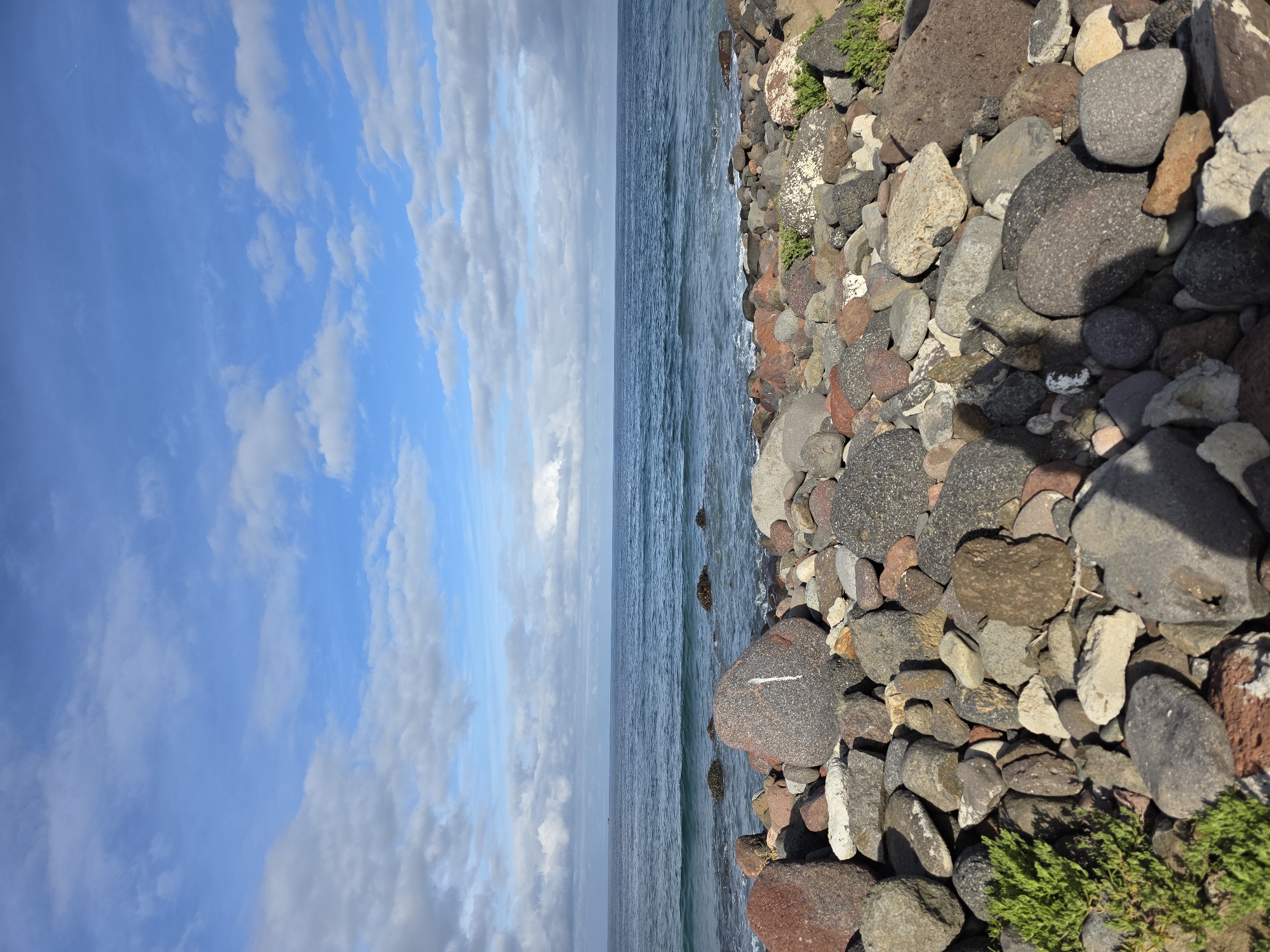 Rocky coastline captured under cloudy skies in Ensenada